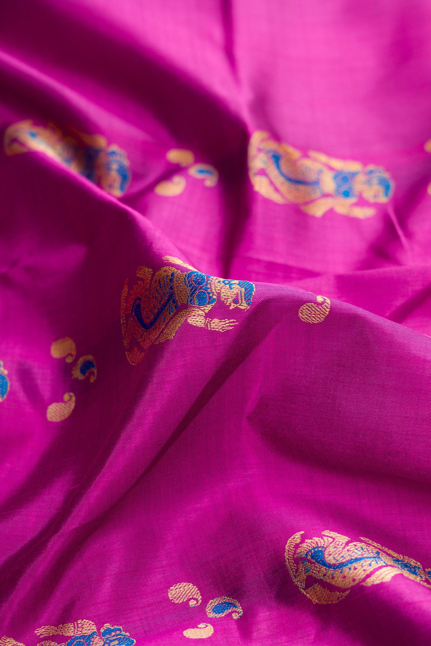Close up of Purple Dual Tone Baluchari Silk Saree with Thread Butta on the body and Fancy Border.  displaying folds