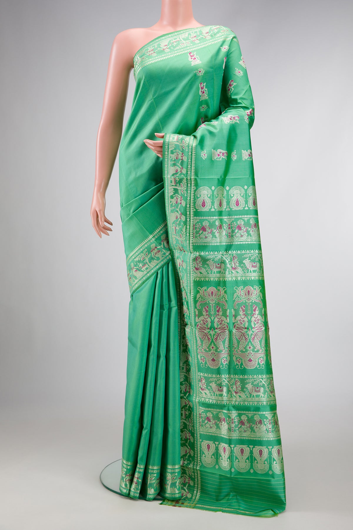 Sea Green Dual Tone Baluchari Silk Saree with Zari And Thread Butta on the body and Zari Border.  displayed on a mannequin