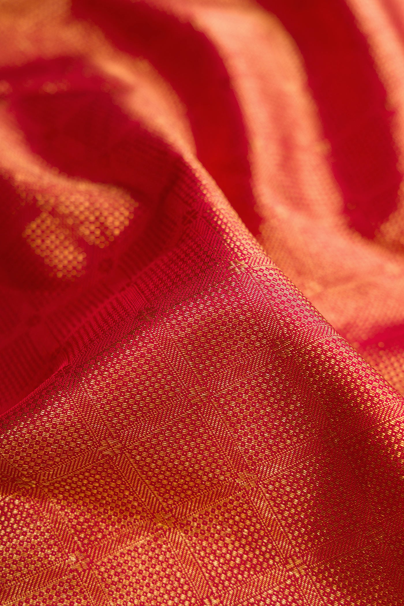 Close up of Maroon Dual Tone Kanchipuram Silk Saree with Zari Brocade on the body and Zari Border.  displaying folds