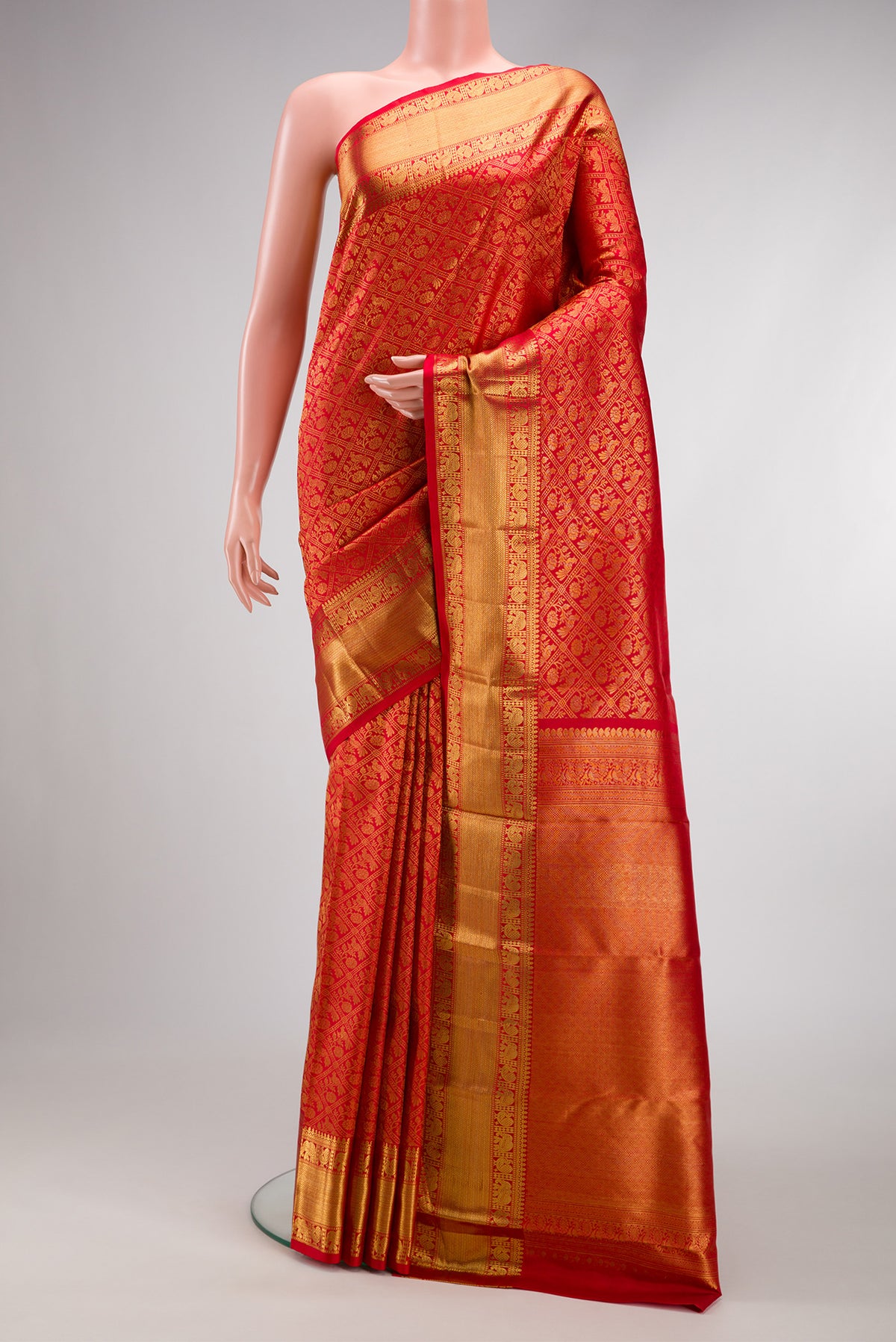 Red Dual Tone Kanchipuram Silk Saree with Zari Brocade on the body and Zari Border.  displayed on a mannequin