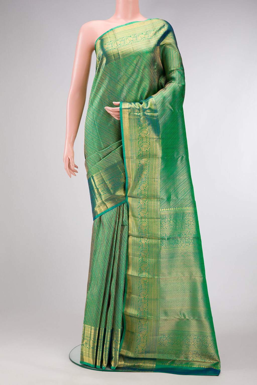 Green Dual Tone Kanchipuram Silk Saree with Zari Brocade on the body and Zari Border.  displayed on a mannequin