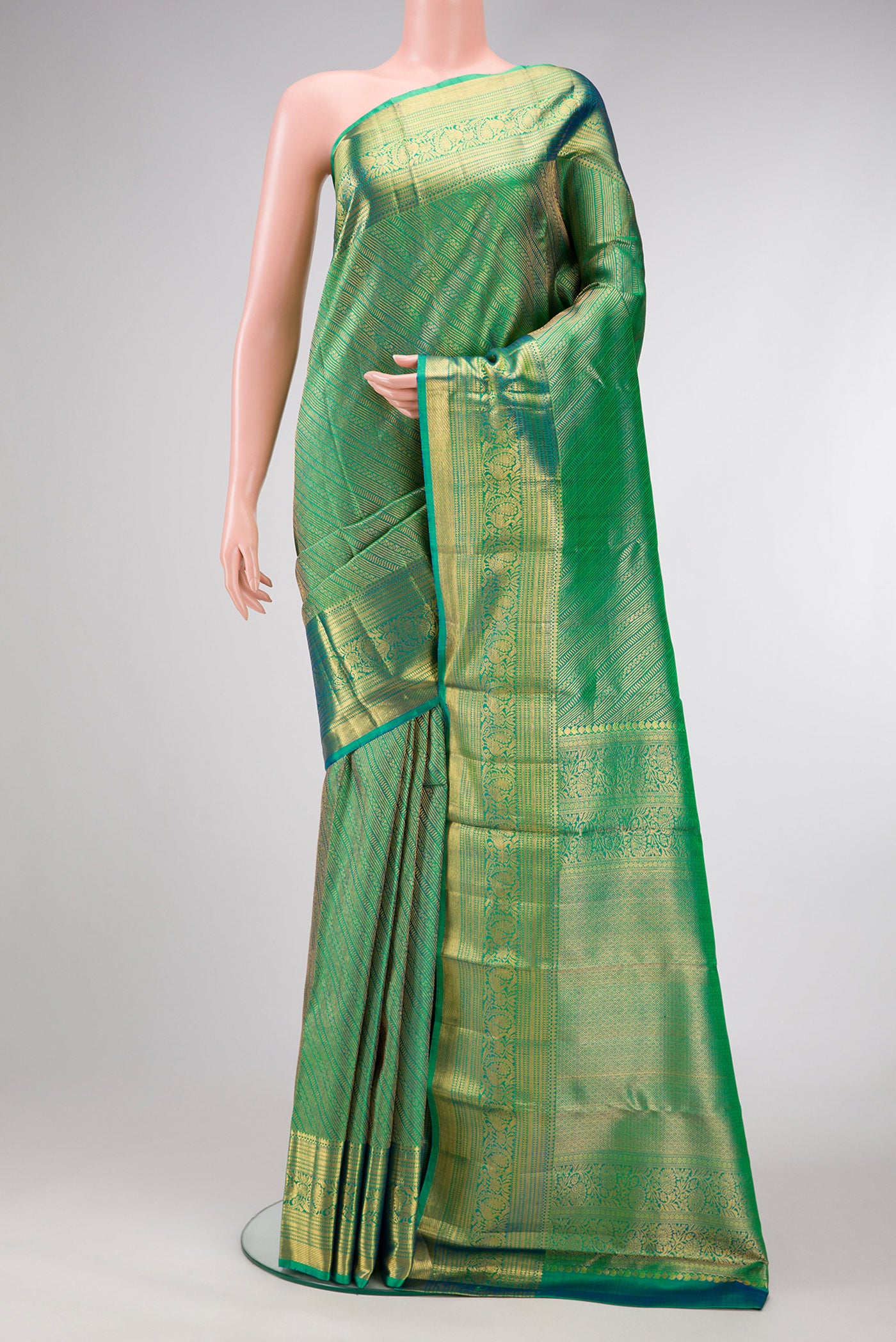 Green Dual Tone Kanchipuram Silk Saree with Zari Brocade on the body and Zari Border.  displayed on a mannequin