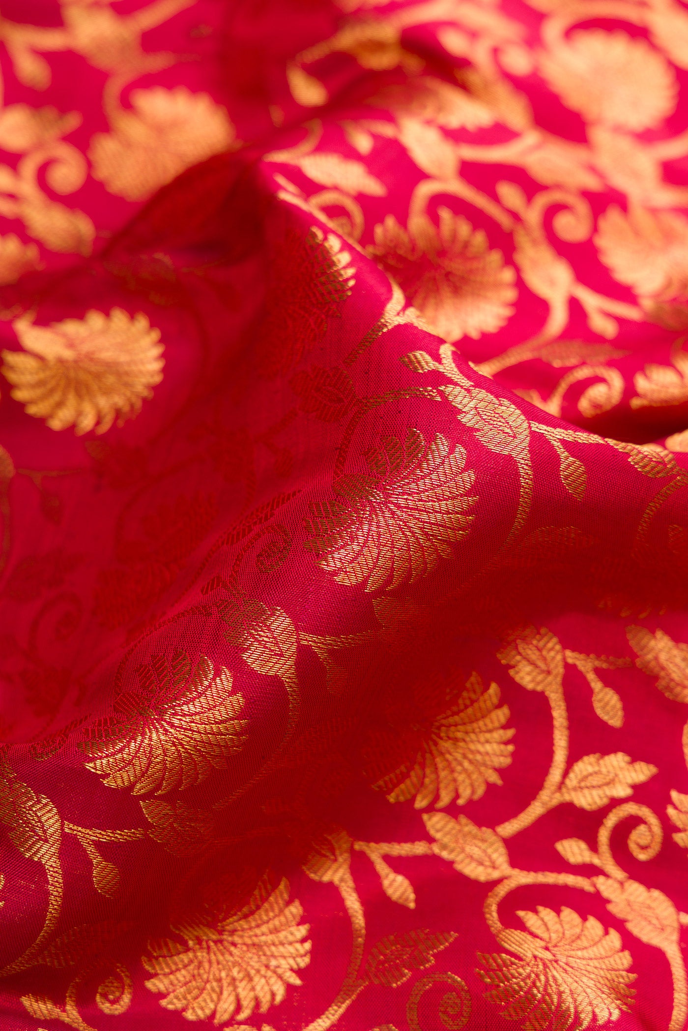 Close up of Maroon Dual Tone Kanchipuram Silk Saree with Zari Brocade on the body and Zari Border.  displaying folds