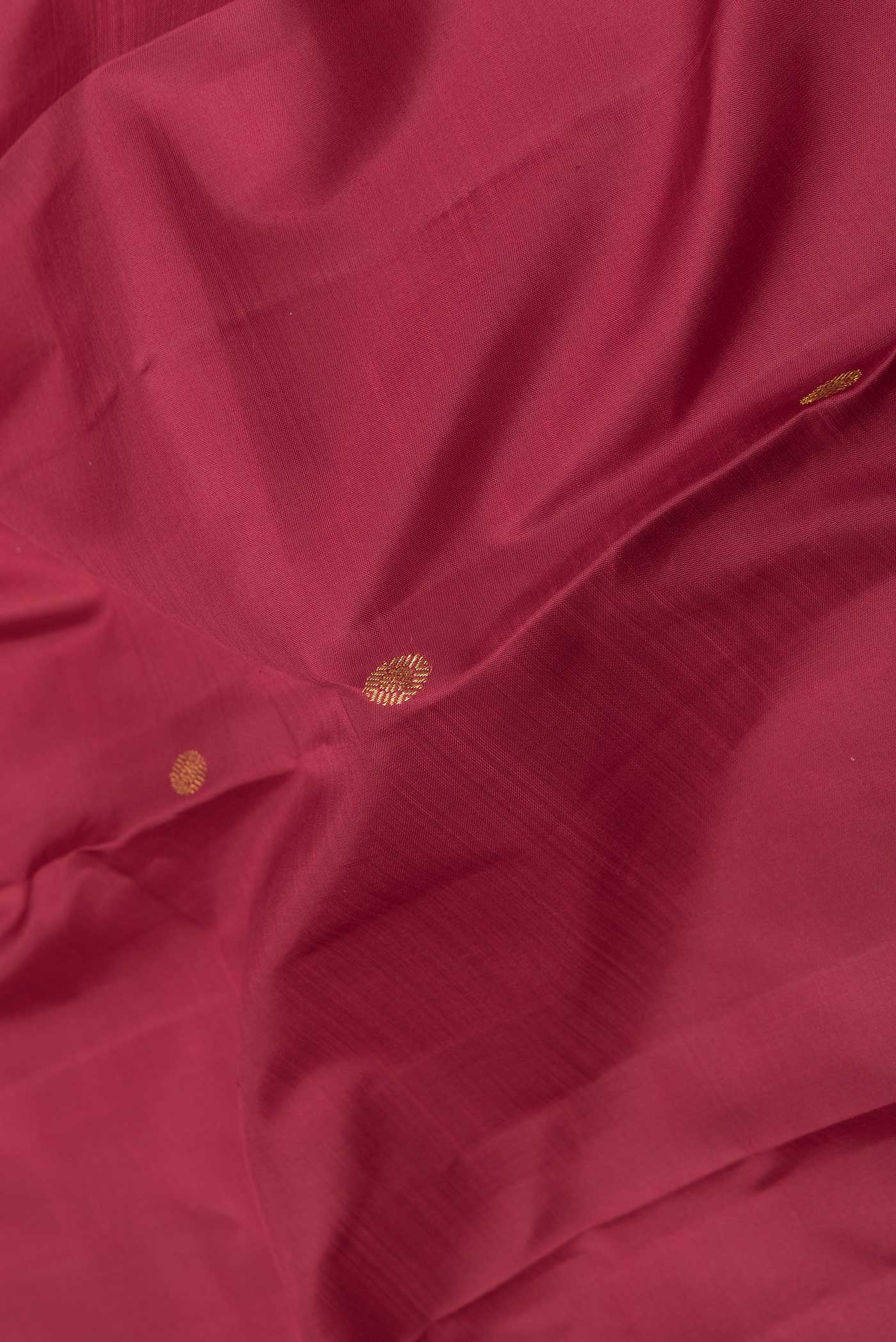 Close up of Maroon Dual Tone Kanchipuram Saree with Zari Butta on the body and Zari Border displaying folds