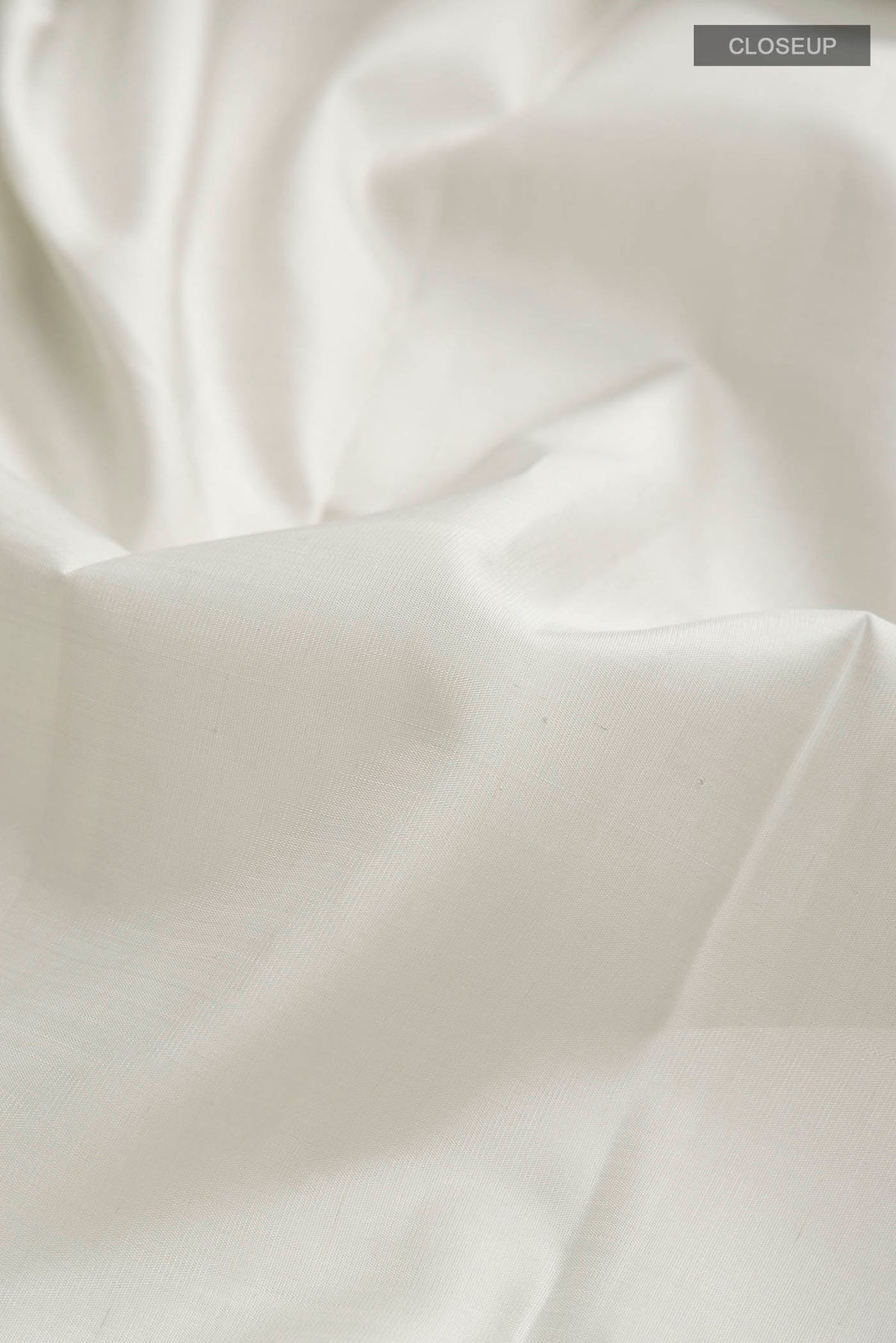 Close up of Grey Kanchipuram Silk Saree with Plain Body and Temple Border displaying folds