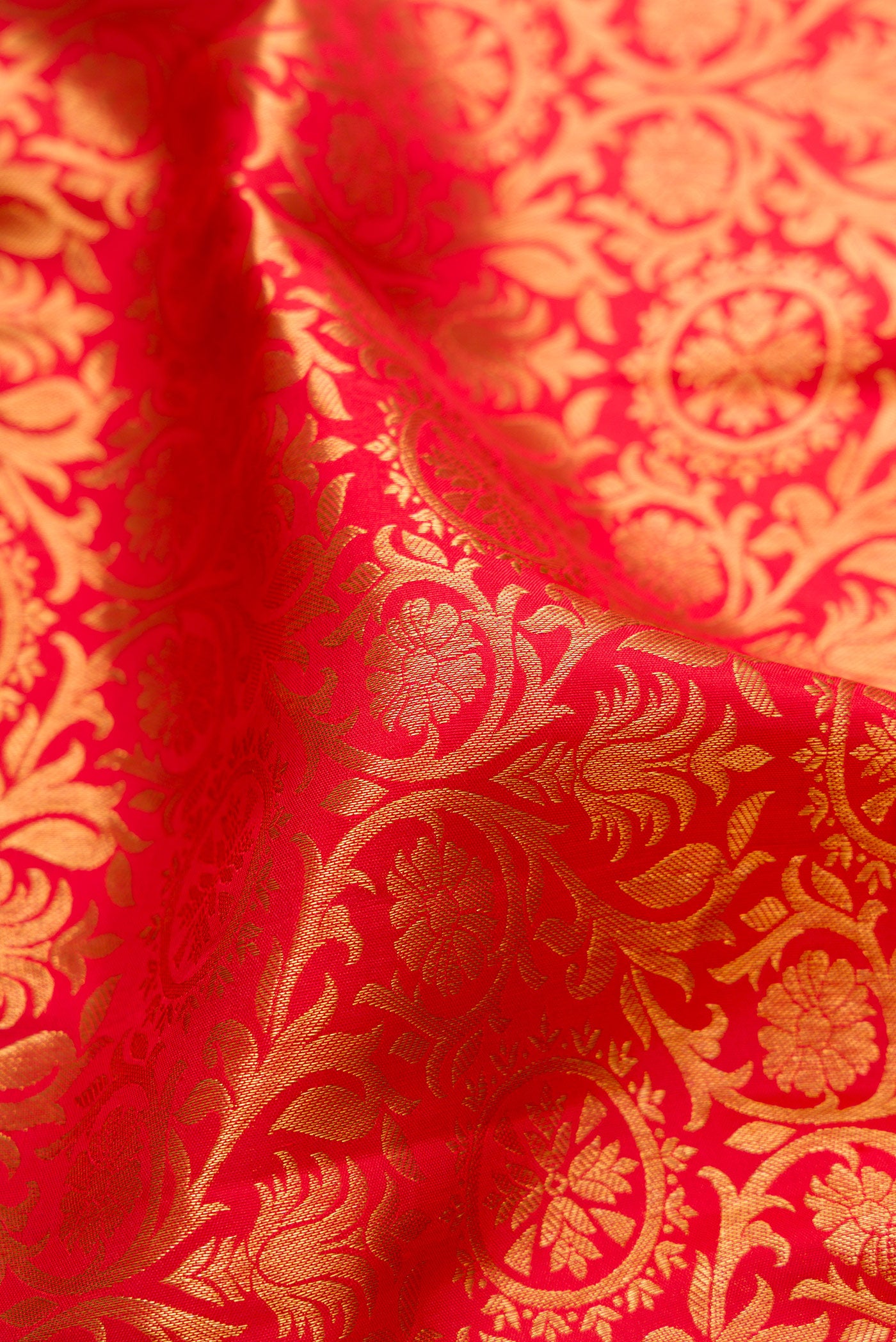 Close up of Red Dual Tone Kanjivaram Silk Saree with Zari Brocade on the body and Zari Border.  displaying folds