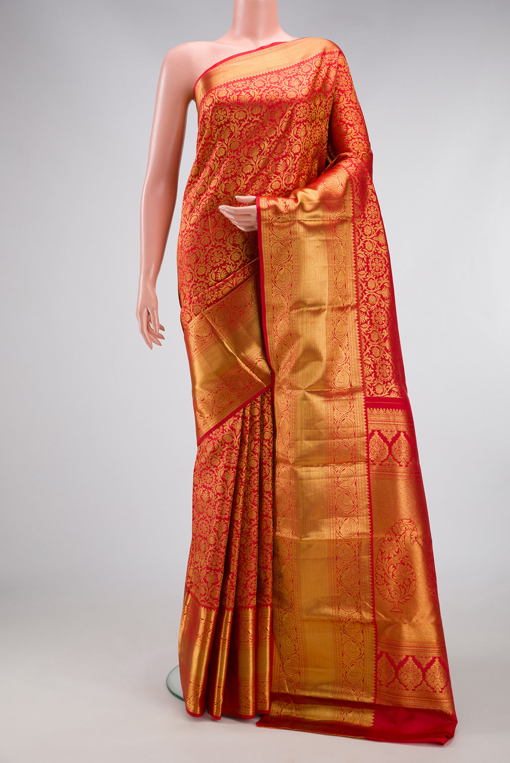 Red Dual Tone Kanjivaram Silk Saree with Zari Brocade on the body and Zari Border.  displayed on a mannequin