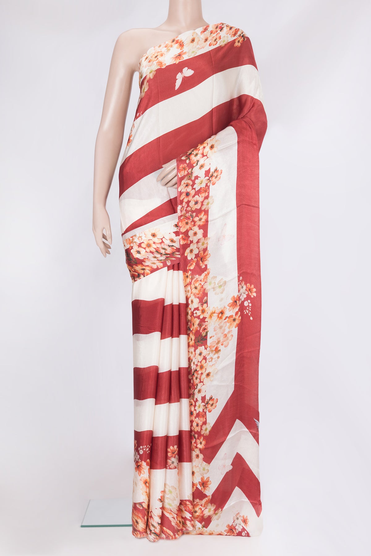 Red Crepe Saree with Printed design on the body and Without Border.  displayed on a mannequin