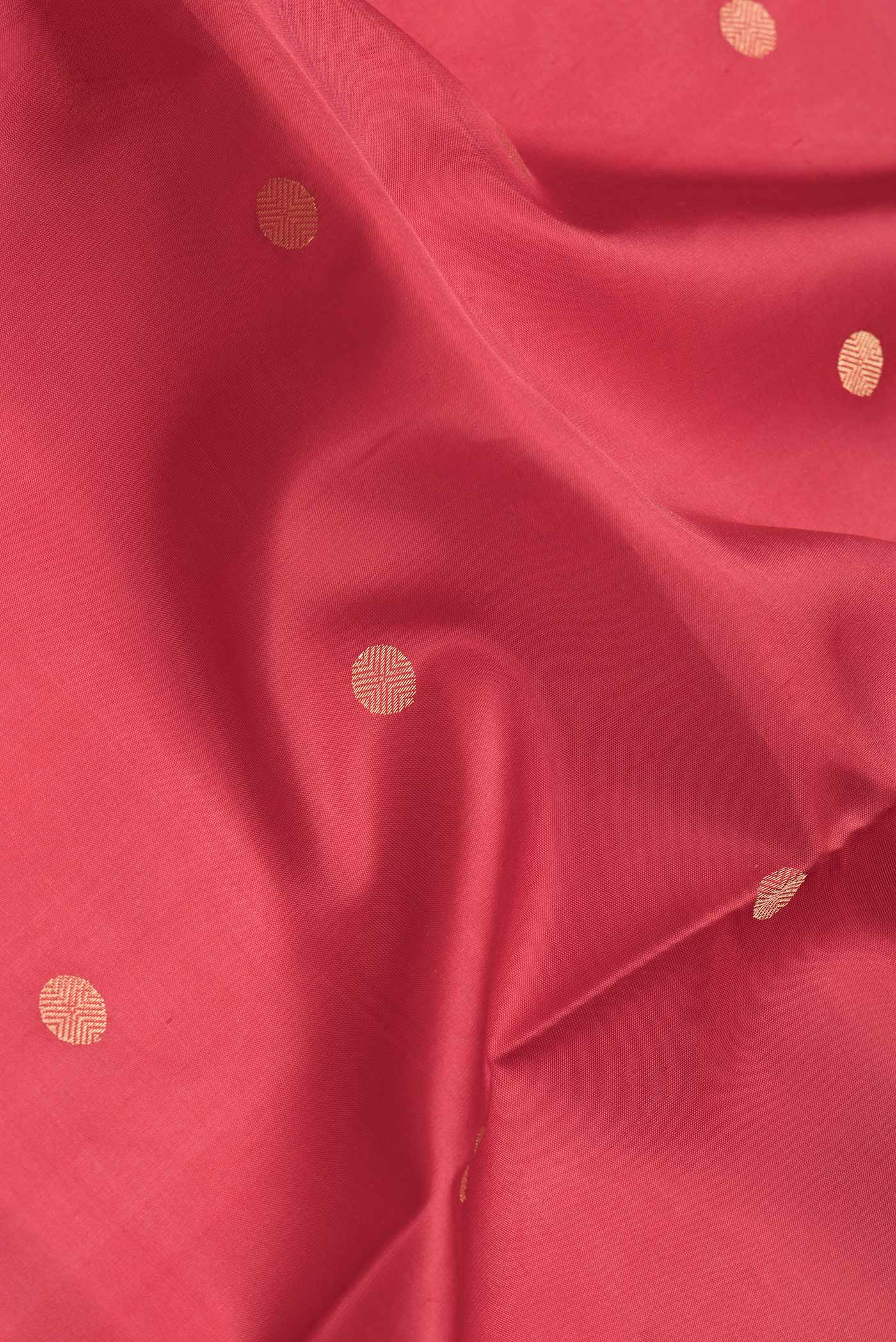 Close up of Red Dual Tone Soft Silk Saree with Zari Butta on the body and Zari Border.  displaying folds