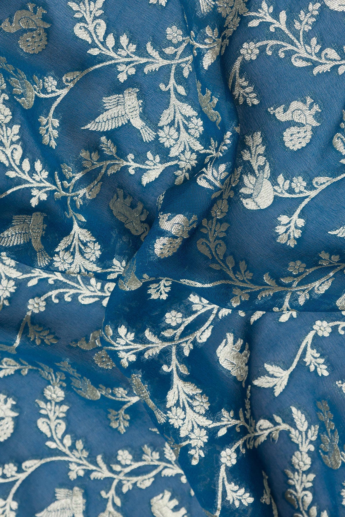 Close up of Peacock Blue Dual Tone Banarasi Georgette Saree with Zari Brocade on the body and Zari Border.  displaying folds