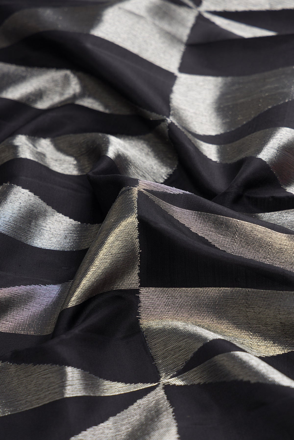 Close up of Black Dual Tone Kanchipuram Tissue Silk Saree with Zari Brocade on the body and Without Border.  displaying folds