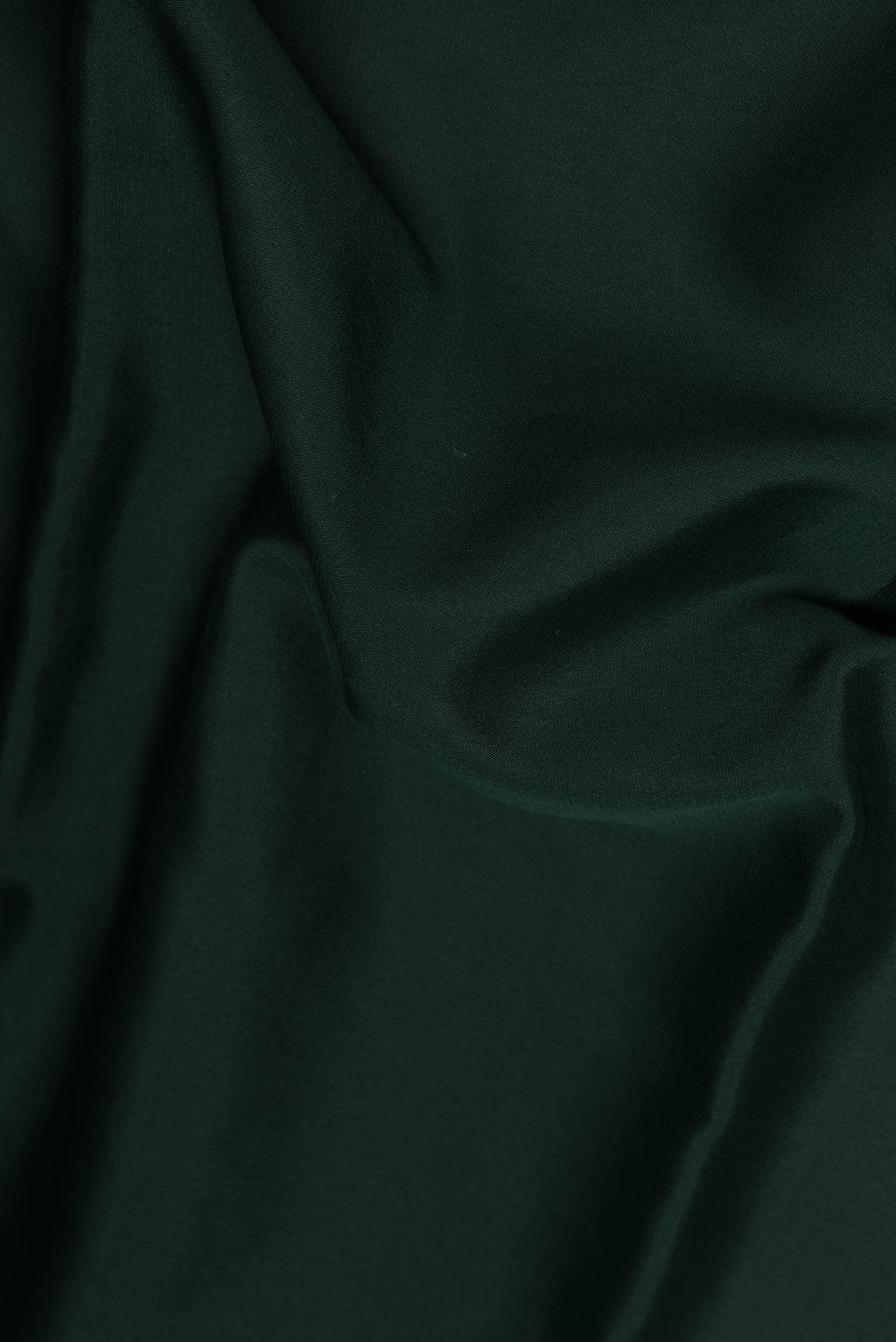 Close up of Bottle Green Mysore Chiffon Saree with Plain Body and Zari Border.  displaying folds