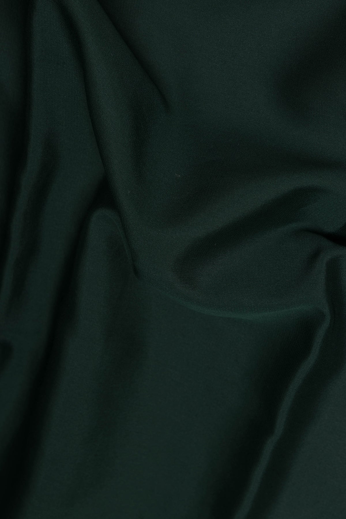 Close up of Bottle Green Mysore Chiffon Saree with Plain Body and Zari Border.  displaying folds