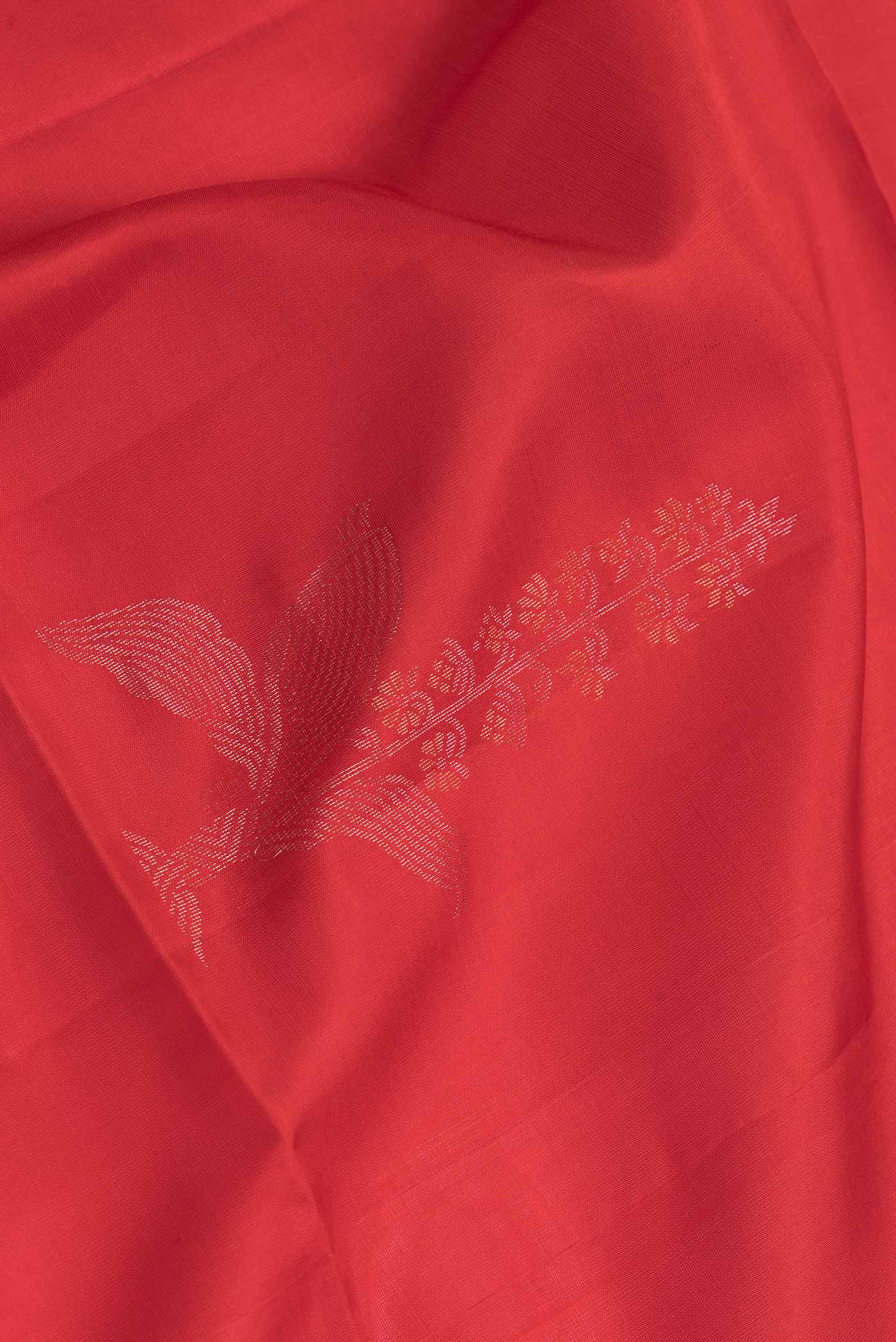 Close up of Red Dual Tone Soft Silk Saree with Zari Butta on the body and Zari Border.  displaying folds