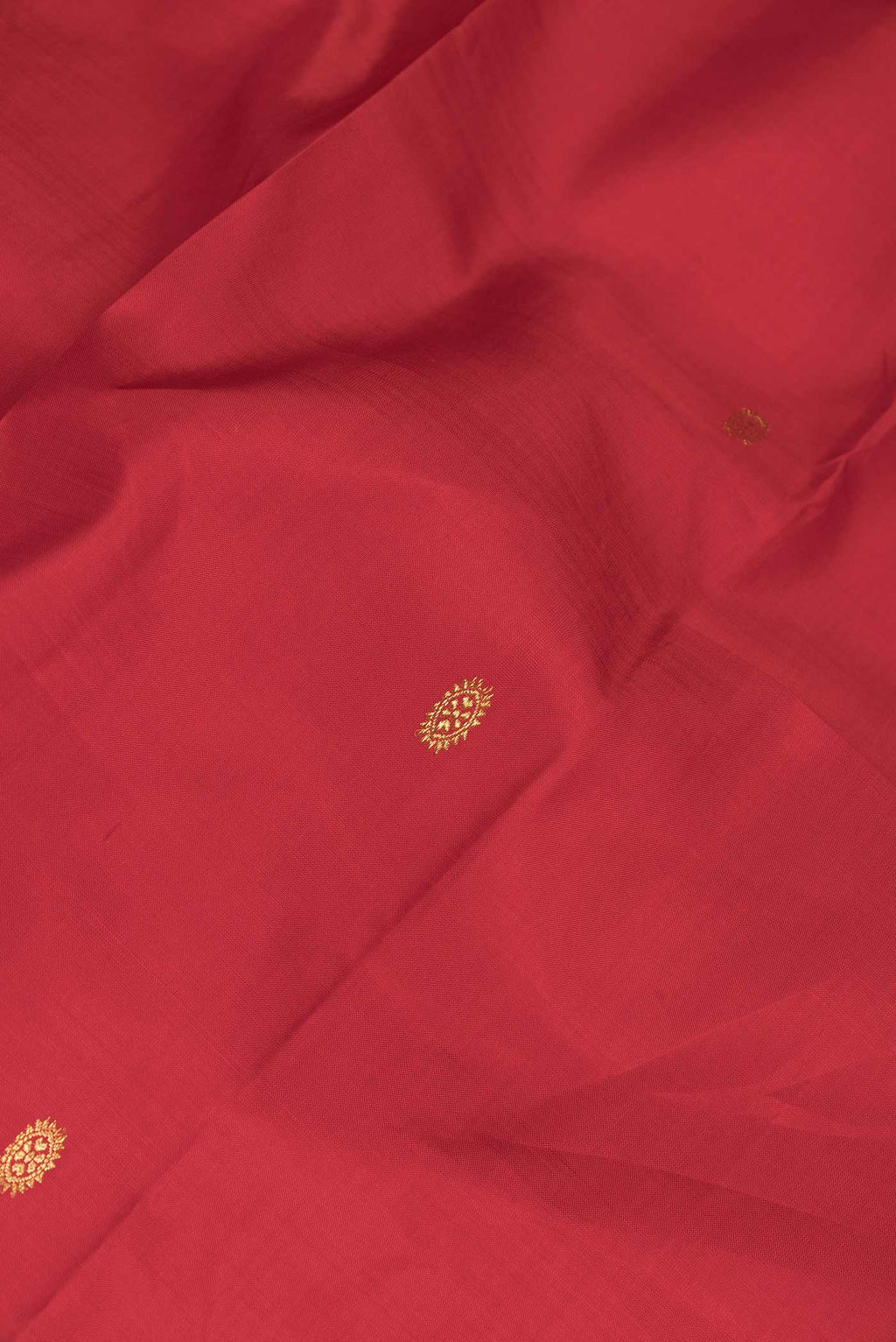 Close up of Red Dual Tone Kanchipuram Silk Saree with Zari Butta on the body and Zari Border displaying folds