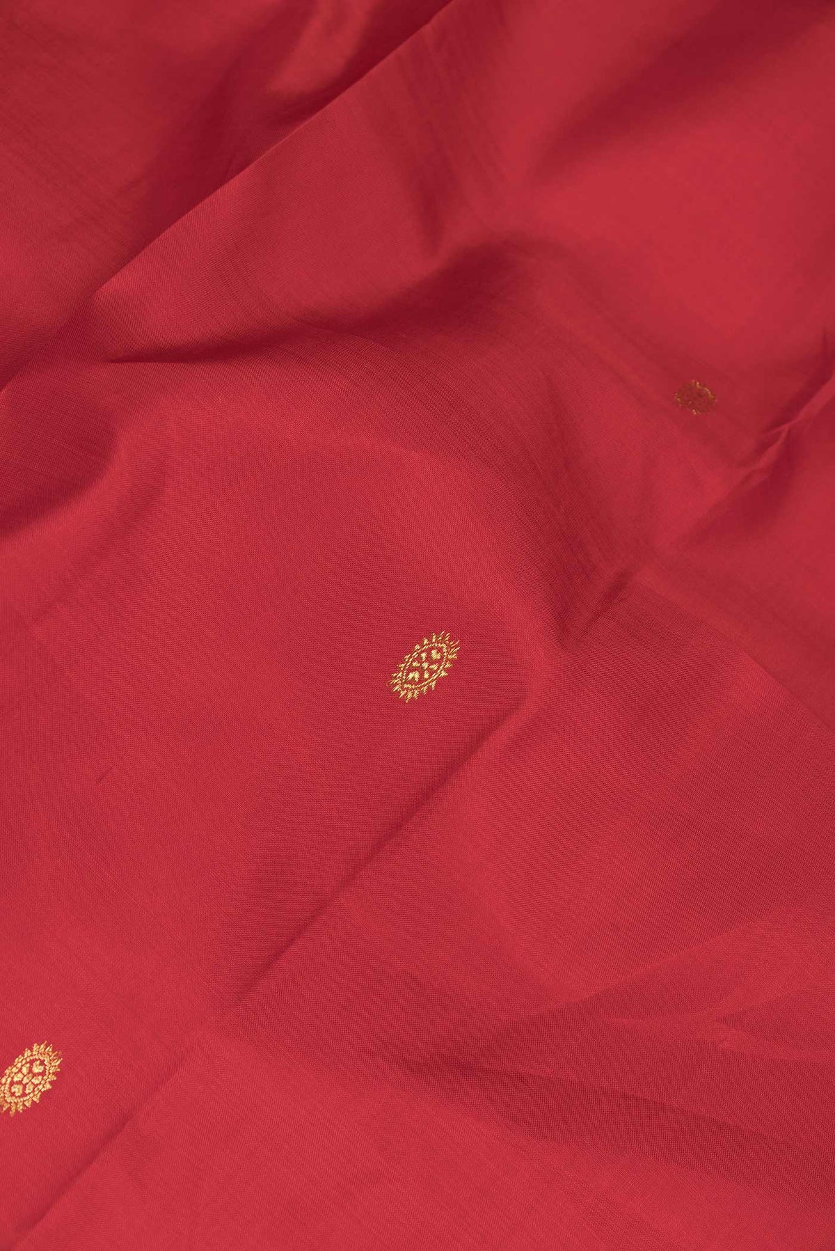 Close up of Red Dual Tone Kanchipuram Silk Saree with Zari Butta on the body and Zari Border displaying folds
