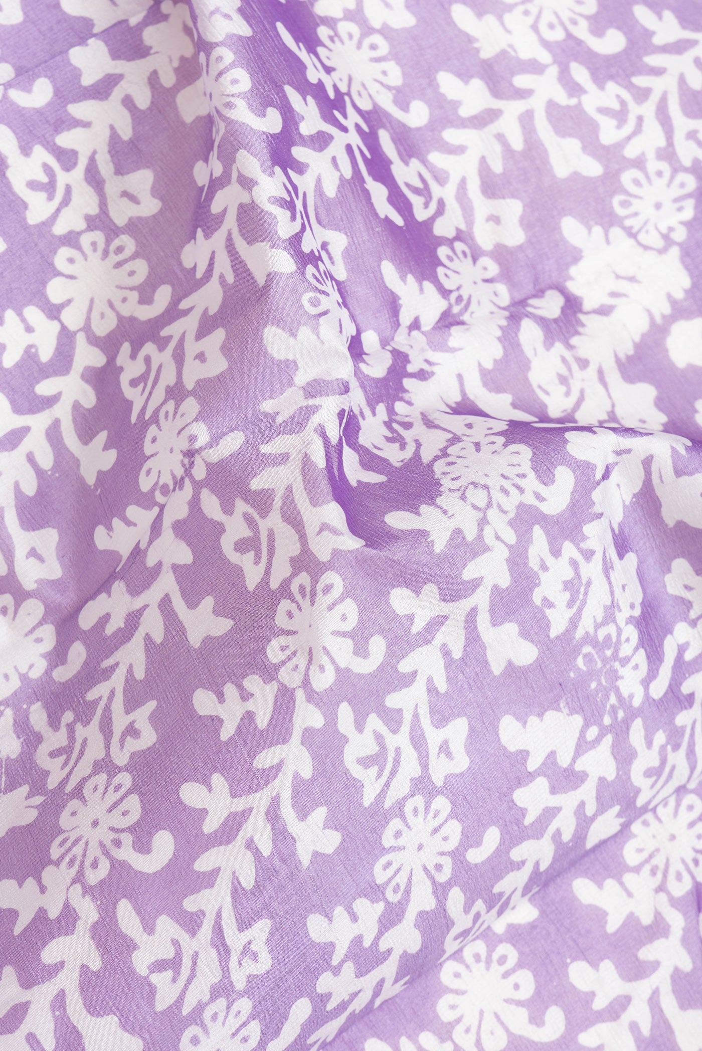 Close up of Lavender Dual Tone Tussar Silk Saree with Printed design on the body and Printed Border.  displaying folds