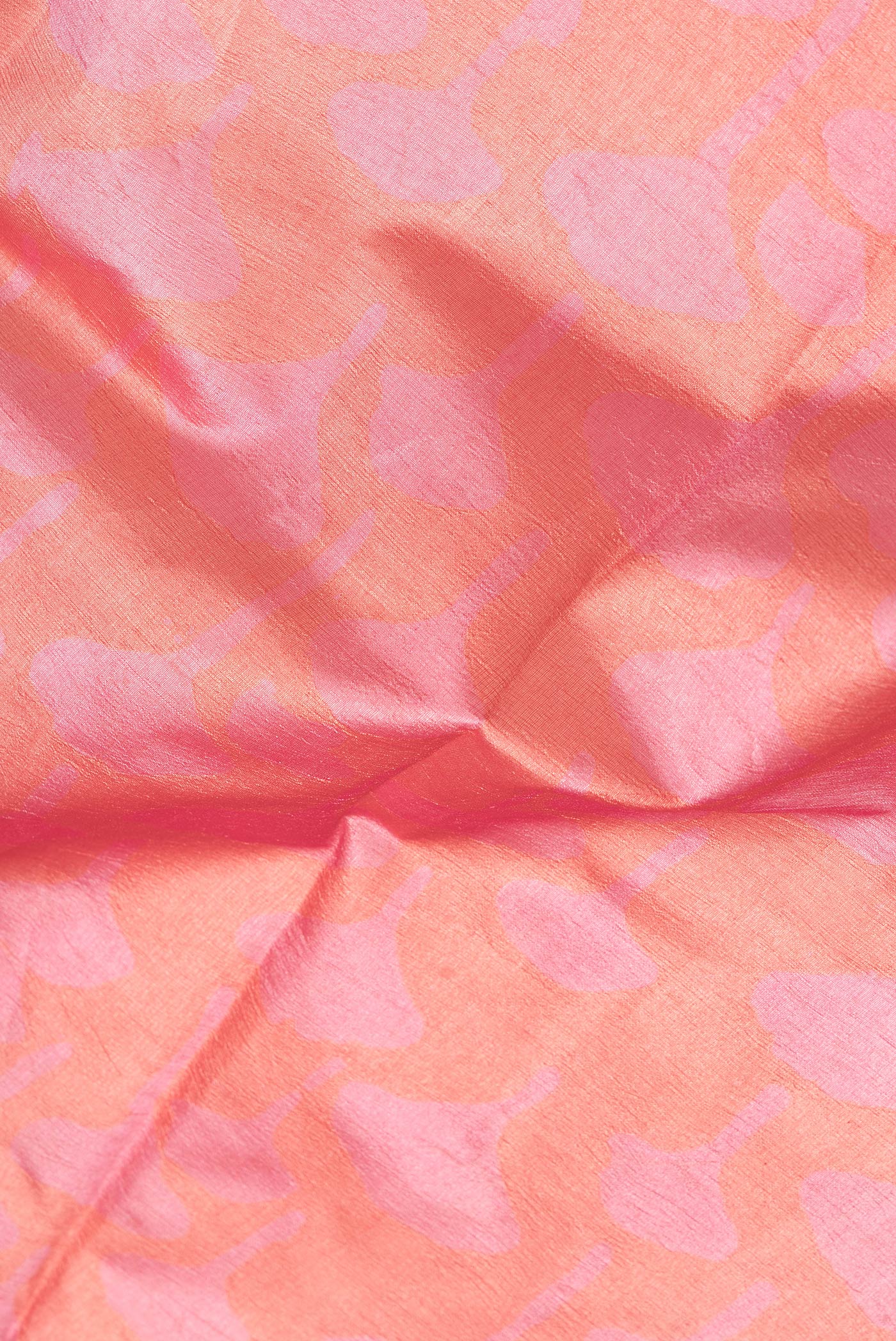 Close up of Dark Pink Dual Tone Tussar Silk Saree with Printed design on the body and Printed Border.  displaying folds