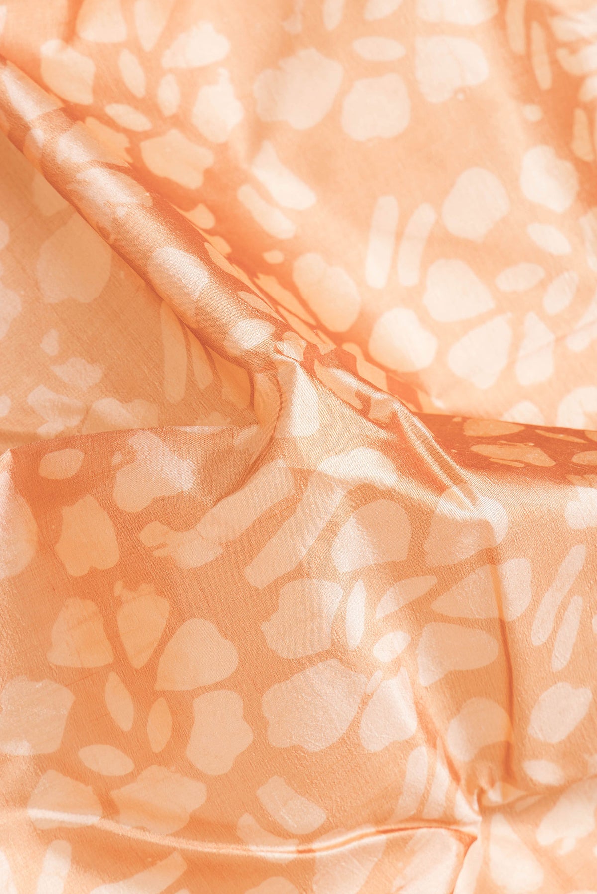 Close up of Sandal Dual Tone Tussar Silk Saree with Printed design on the body and Printed Border.  displaying folds