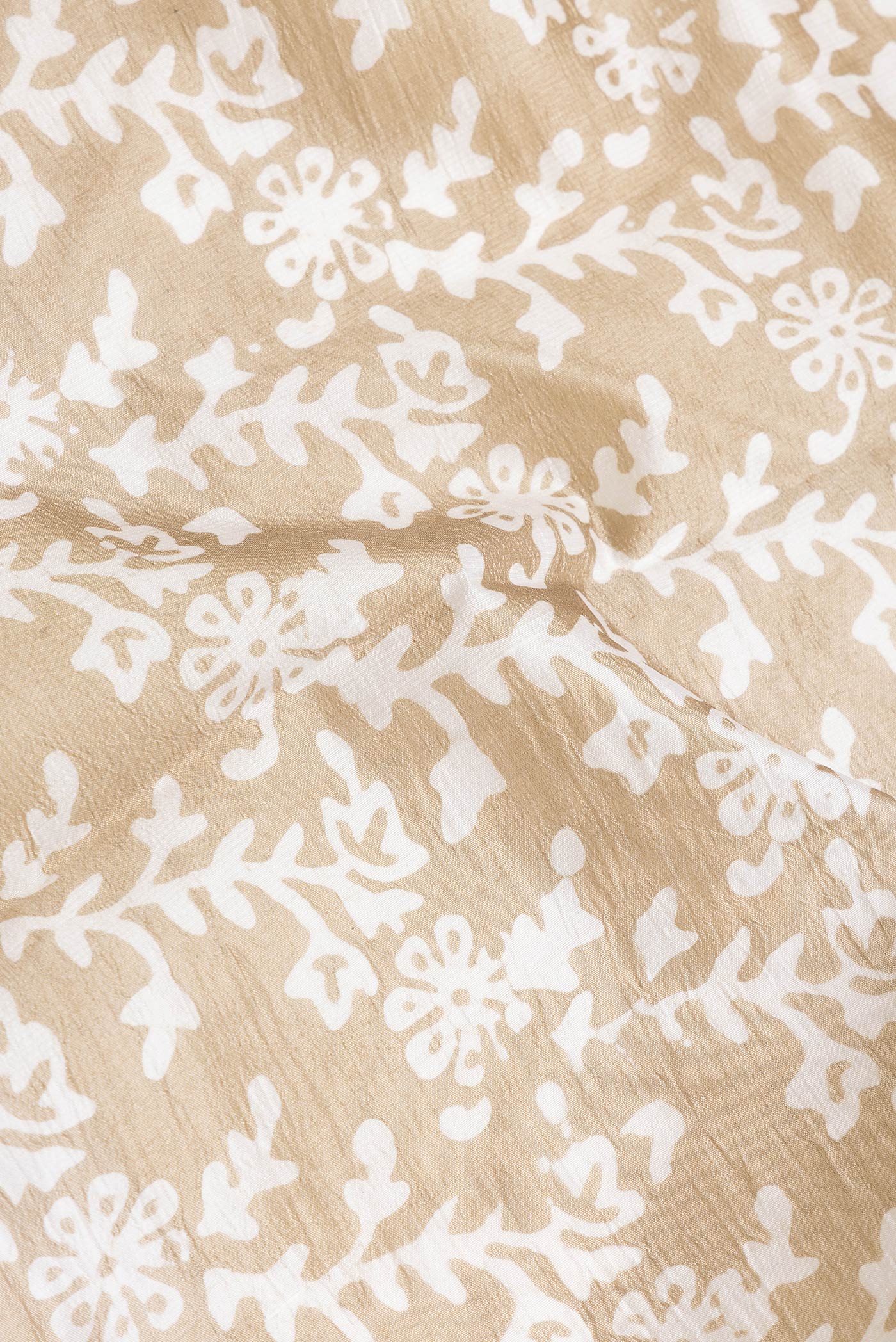 Close up of Beige Dual Tone Tussar Silk Saree with Printed design on the body and Printed Border.  displaying folds