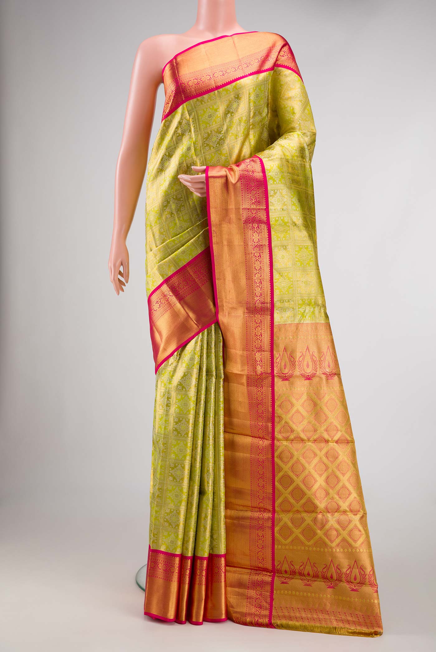 Pista Green Dual Tone Kanjivaram Tissue Silk Saree with Zari Brocade on the body and Zari Border.  displayed on a mannequin