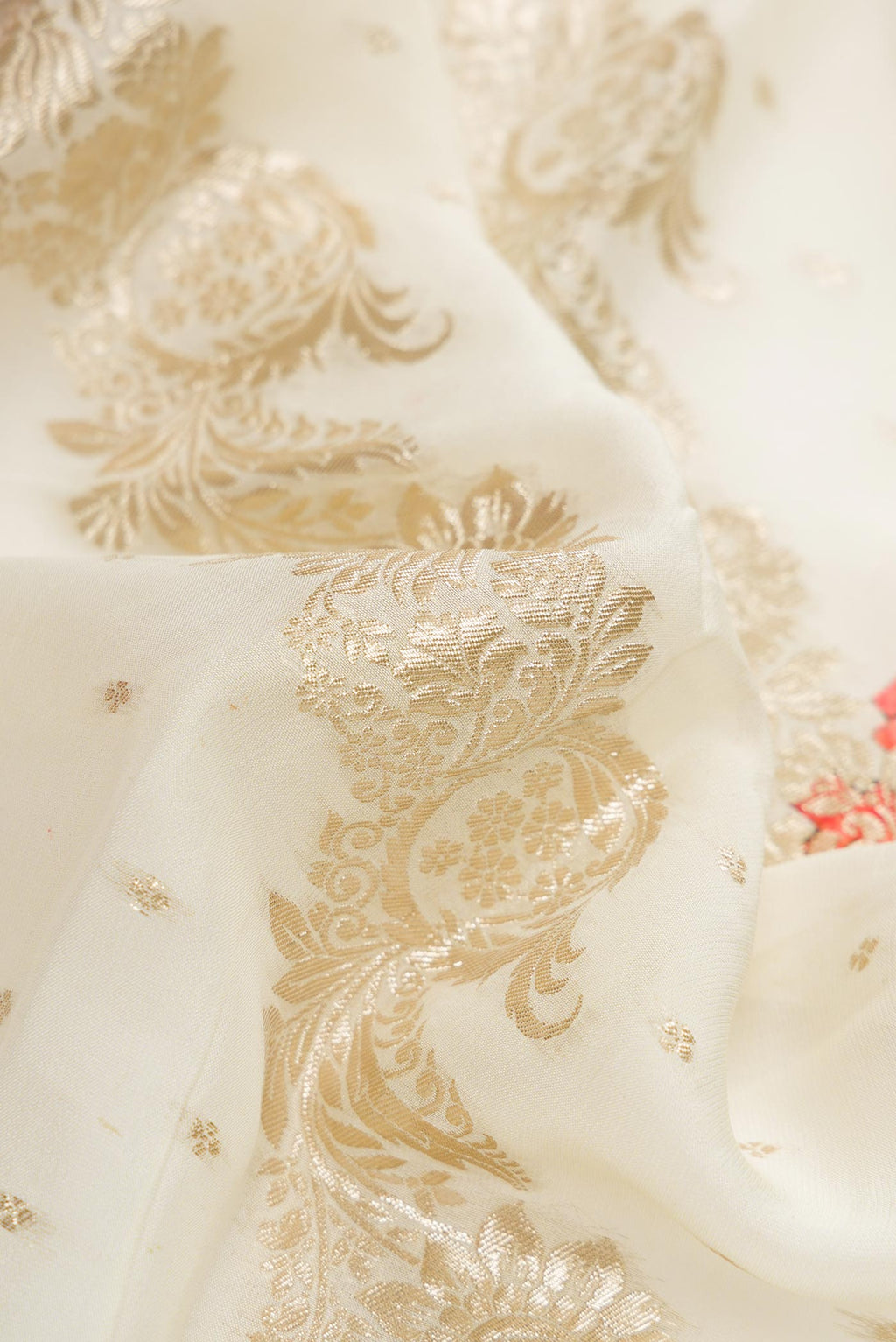 Close up of Off White Dual Tone Mysore Georgette Saree with Zari Butta on the body and Embroidery Border.  displaying folds