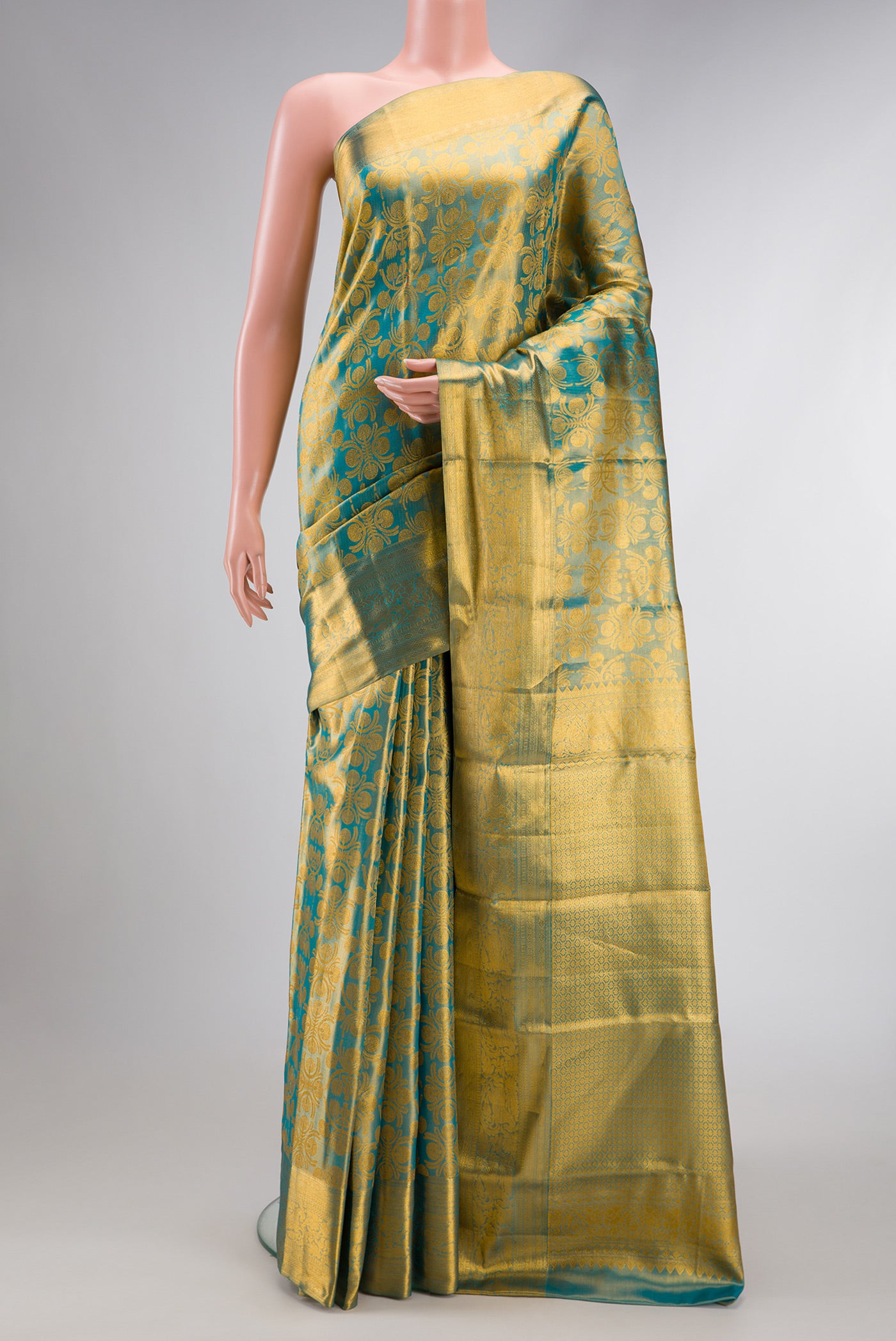 Sky Blue Dual Tone Kanchipuram Tissue Silk Saree with Zari Brocade on the body and Zari Border.  displayed on a mannequin