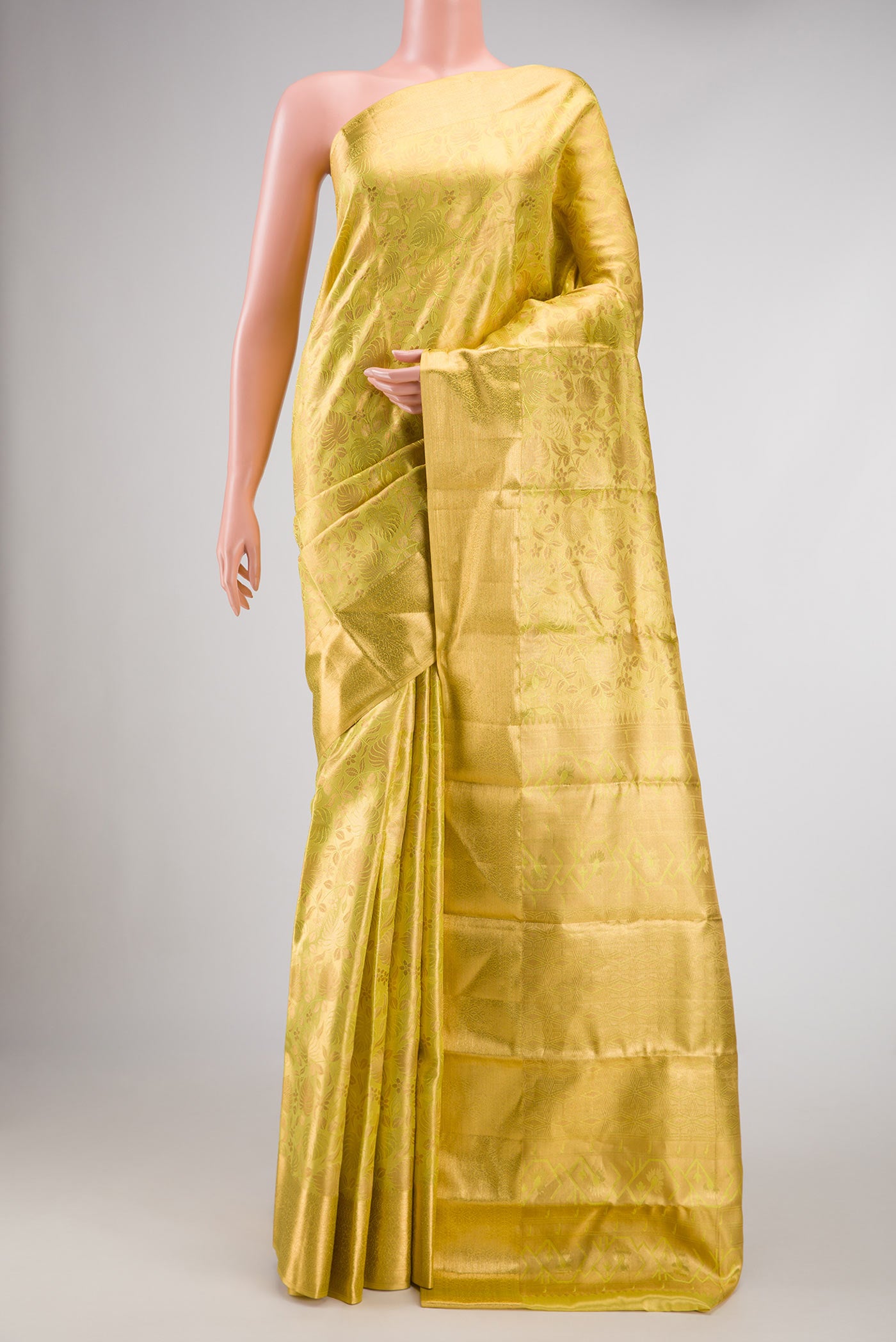 Green Dual Tone Kanchipuram Tissue Silk Saree with Zari Brocade on the body and Zari Border.  displayed on a mannequin