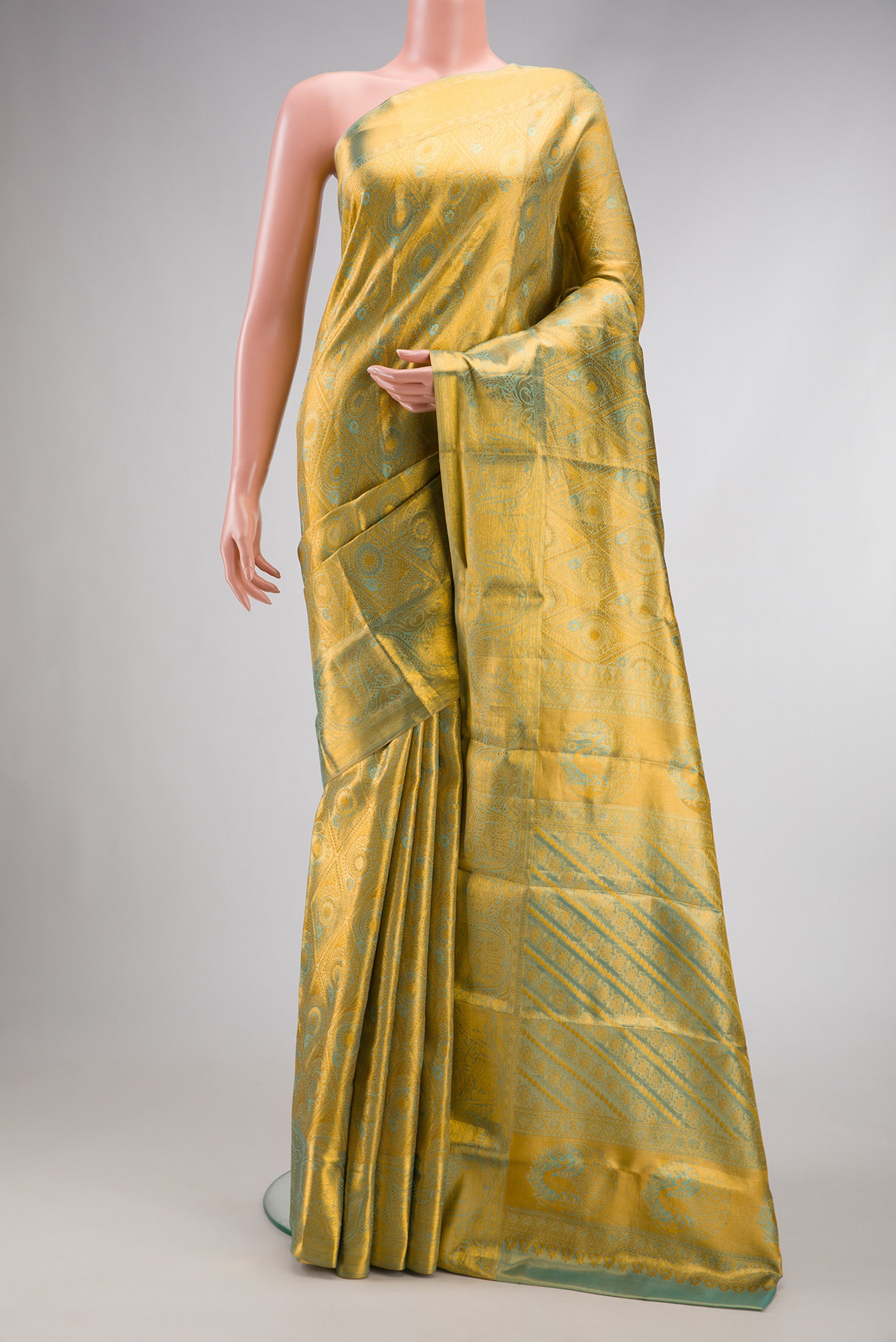 Gold Dual Tone Kanchipuram Tissue Silk Saree with Zari Brocade on the body and Zari Border.  displayed on a mannequin
