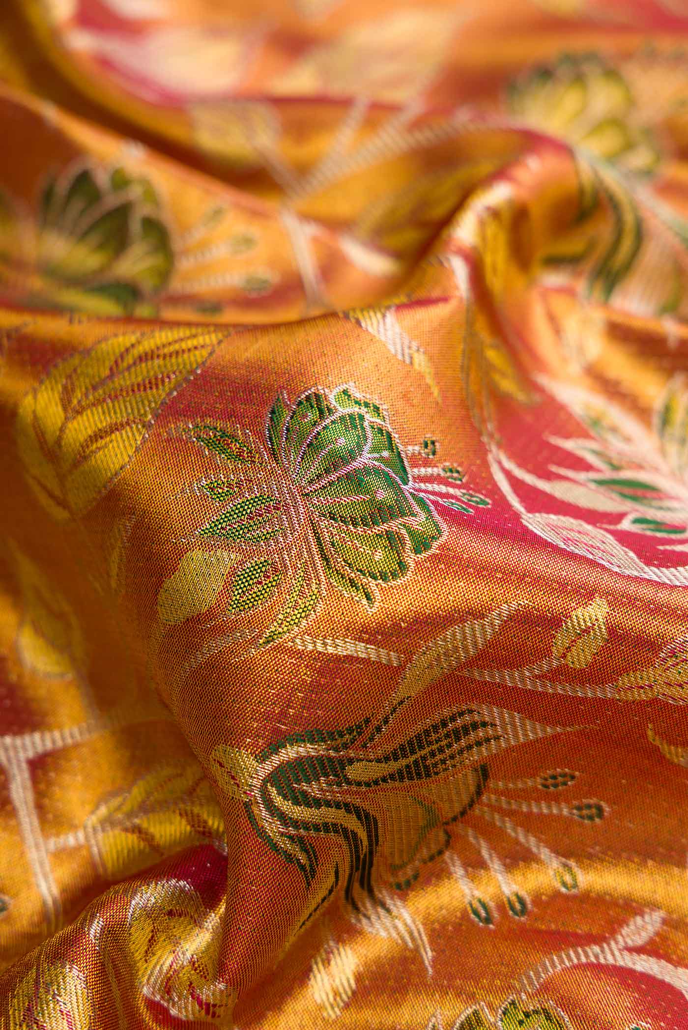 Close up of Gold Dual Tone Kanchipuram Tissue Silk Saree with Zari Brocade on the body and Zari Border.  displaying folds