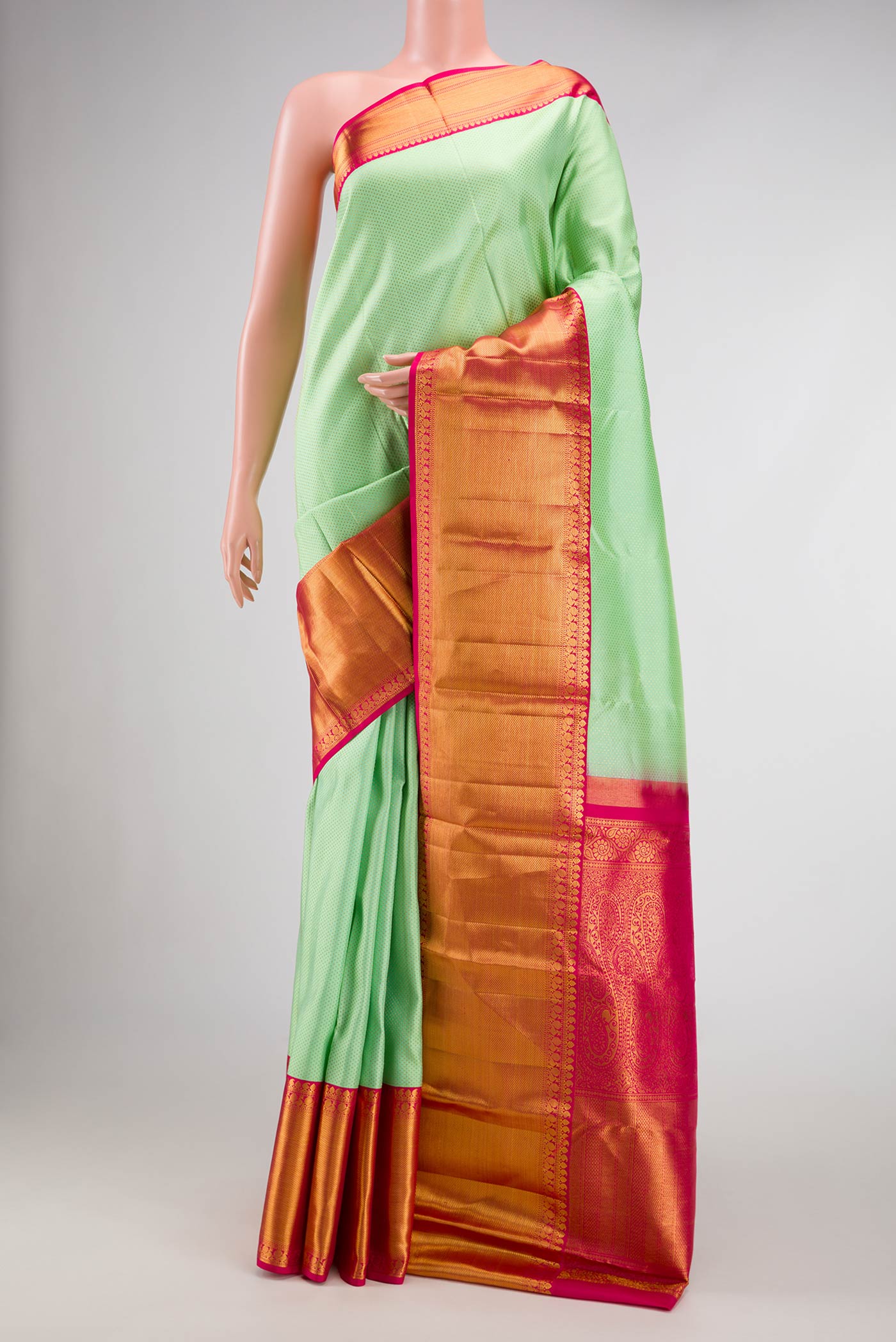 Pista Green Dual Tone Kanjivaram Silk Saree with Zari Brocade on the body and Zari Border.  displayed on a mannequin