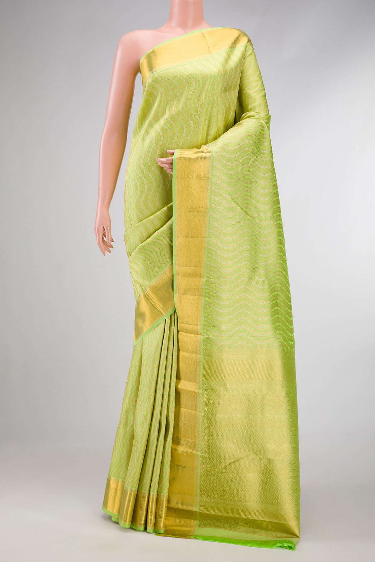 Pista Green Dual Tone Kanjivaram Silk Saree with Zari Brocade on the body and Zari Border.  displayed on a mannequin