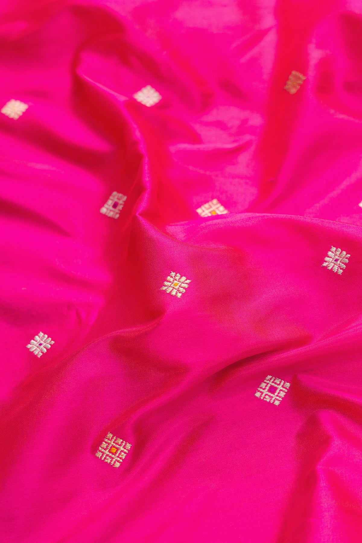 Close up of Pink Dual Tone Banarasi Silk Saree with Zari Butta on the body and Zari Border.  displaying folds