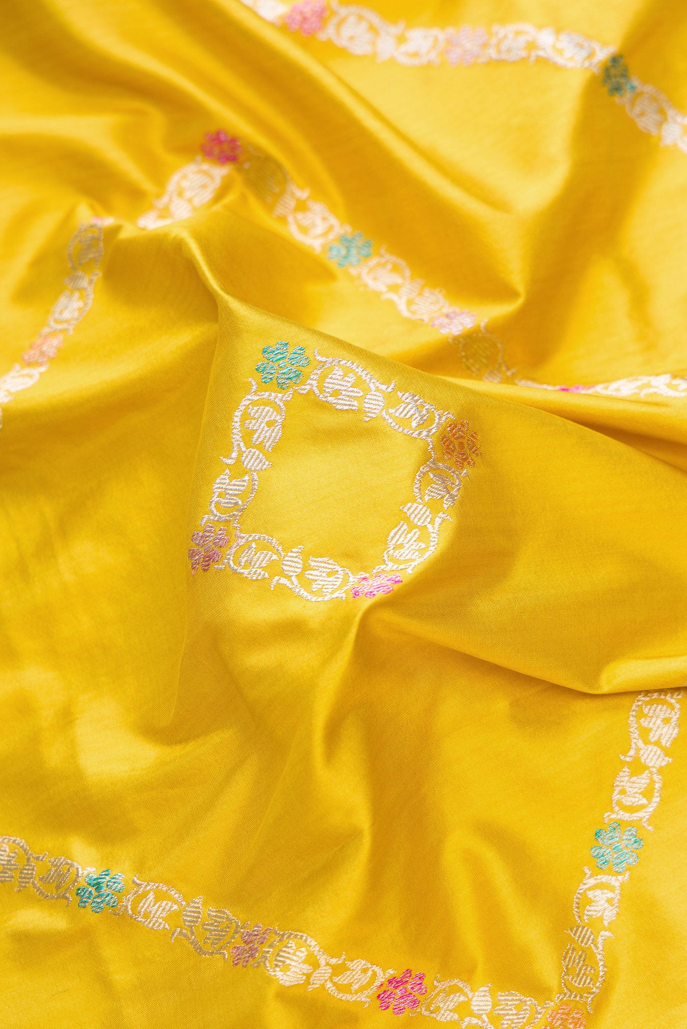 Close up of Mehandi Green Dual Tone Banarasi Silk Saree with Zari Butta on the body and Zari Border.  displaying folds