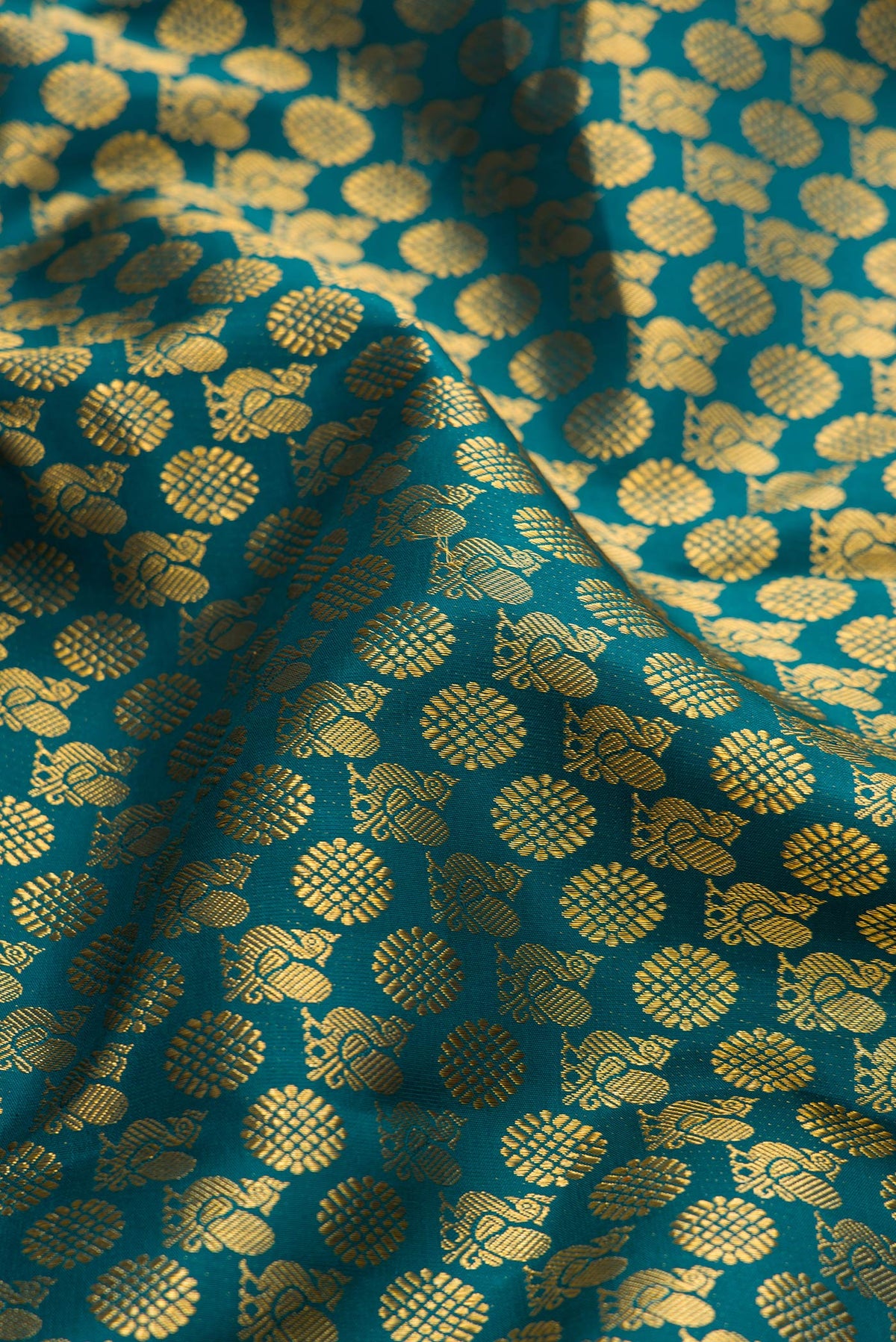 Close up of Bottle Green Dual Tone Kanchipuram Silk Saree with Zari Brocade on the body and Zari Border.  displaying folds