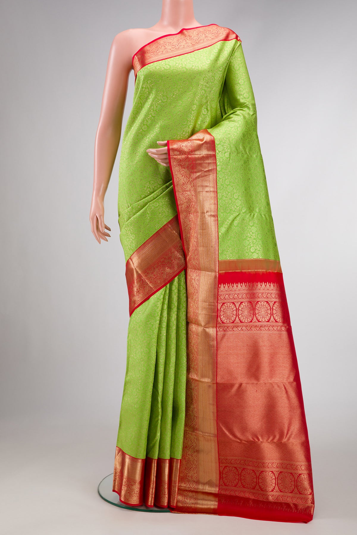 Parrot Green Dual Tone Kanchipuram Silk Saree with Zari Brocade on the body and Zari Border.  displayed on a mannequin