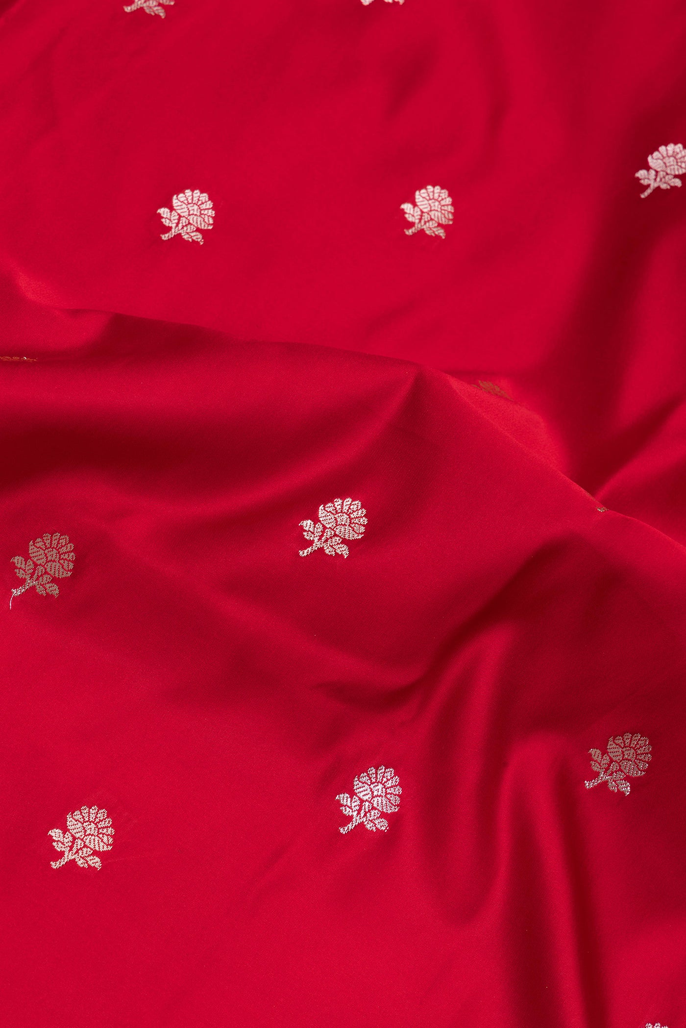 Close up of Red Blended Banarasi Silk Saree with Zari Butta on the body and Zari Border.  displaying folds