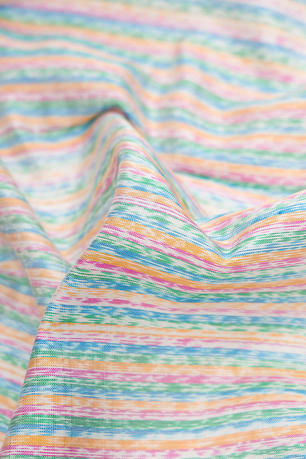 Close up of Grey Dual Tone Rajkot Patola Silk Saree with Ikat Print on the body and Ikat Border displaying folds