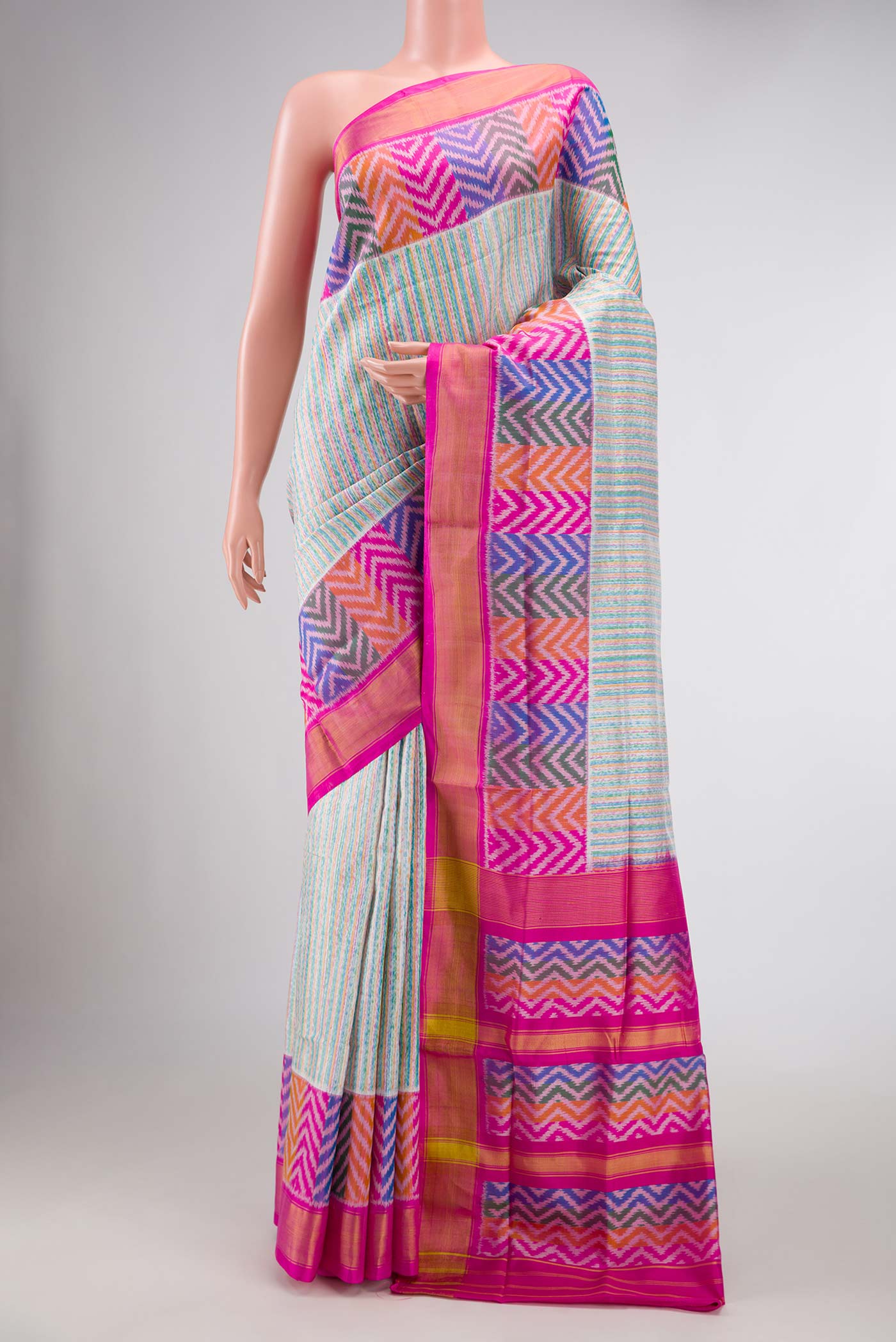 Grey Dual Tone Rajkot Patola Silk Saree with Ikat Print on the body and Ikat Border displayed on a mannequin