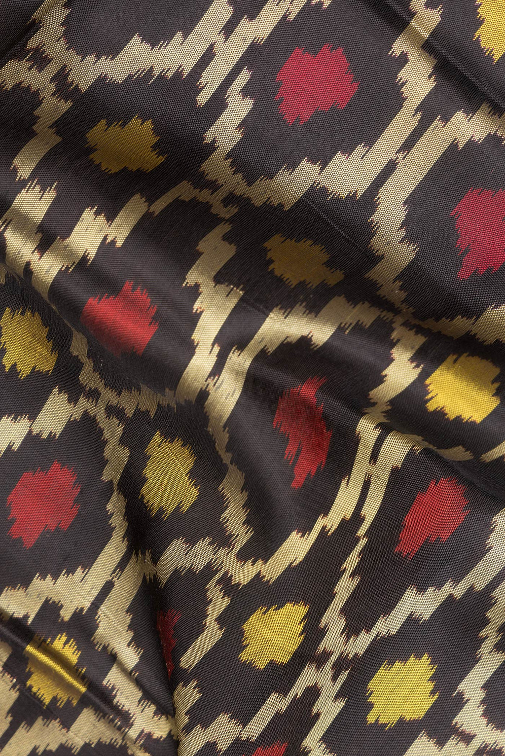 Close up of Pure Silk Black Rajkot Patola Saree with Pure Ikat on the body and Ikat Border.  displaying folds