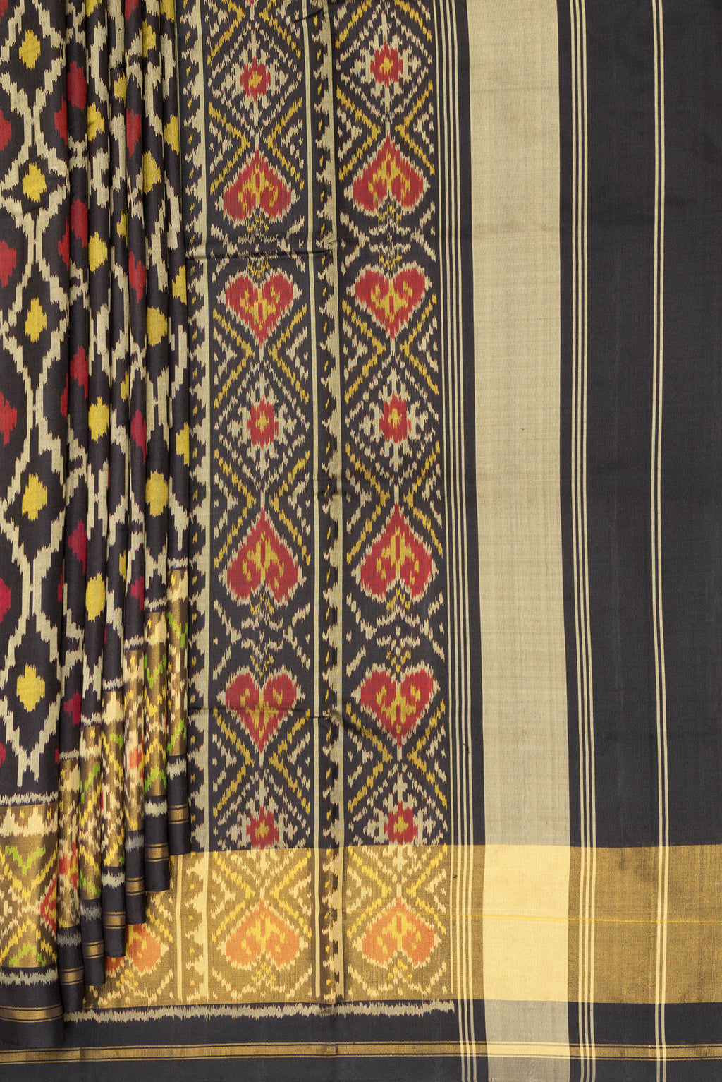 Pleats and pallu of Pure Silk Black Rajkot Patola Saree with Pure Ikat on the body and Ikat Border. 