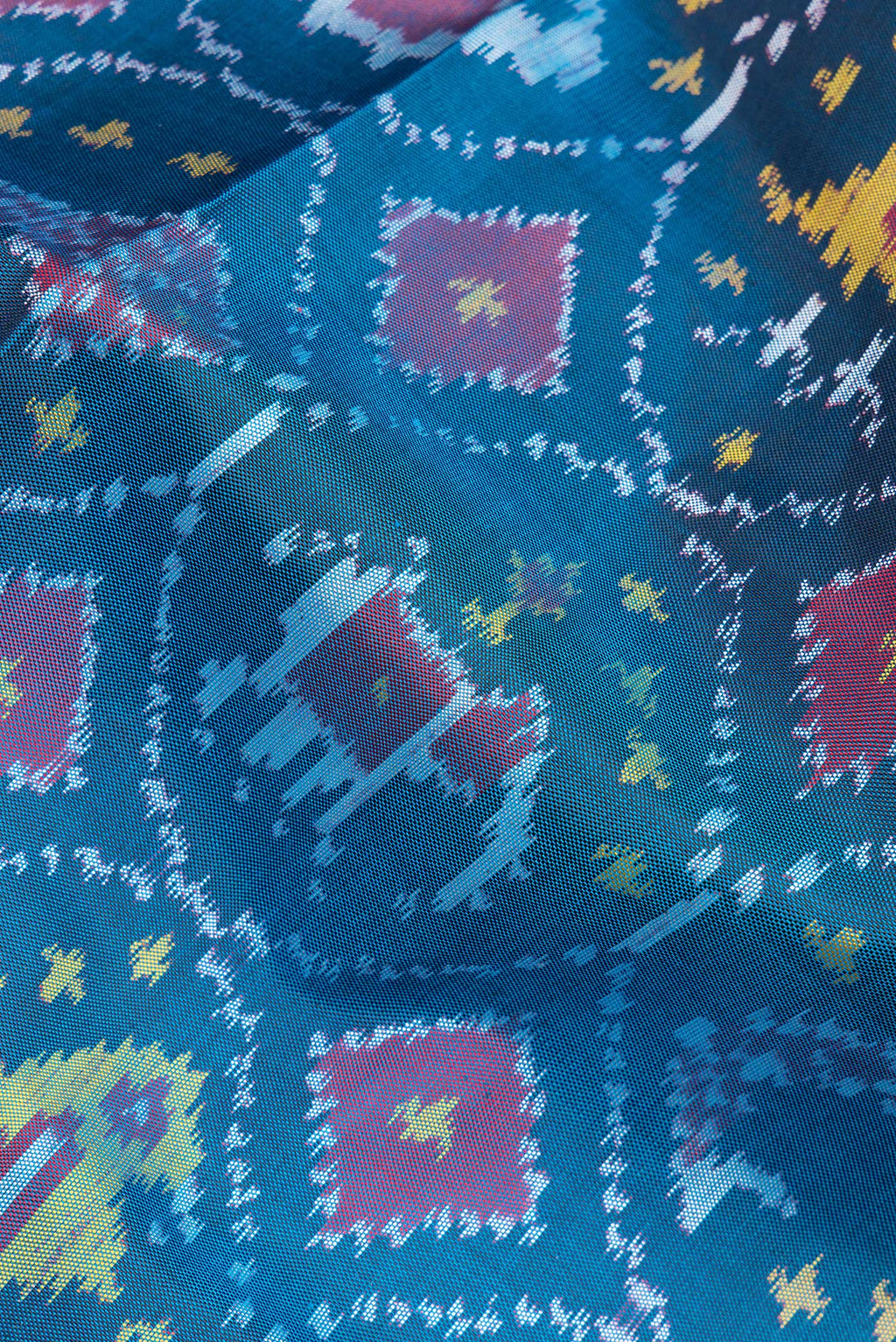 Close up of Pure Silk Peacock Blue Rajkot Patola Saree with Pure Ikat on the body and Ikat Border.  displaying folds