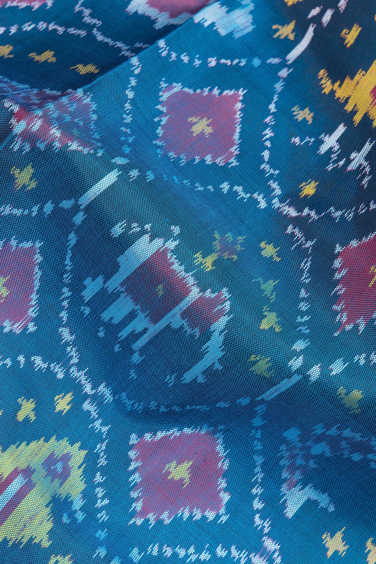 Close up of Pure Silk Peacock Blue Rajkot Patola Saree with Pure Ikat on the body and Ikat Border.  displaying folds