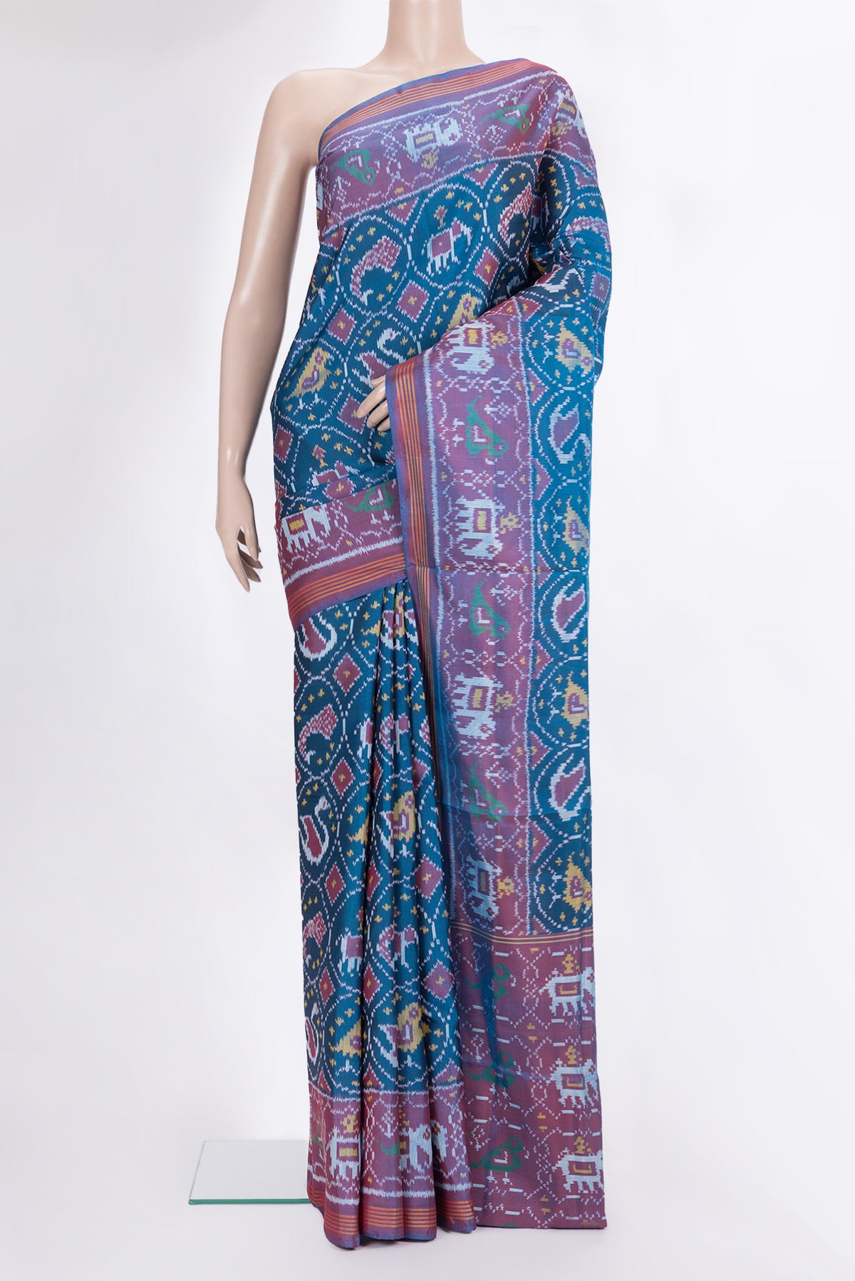 Pure Silk Peacock Blue Rajkot Patola Saree with Pure Ikat on the body and Ikat Border.  displayed on a mannequin
