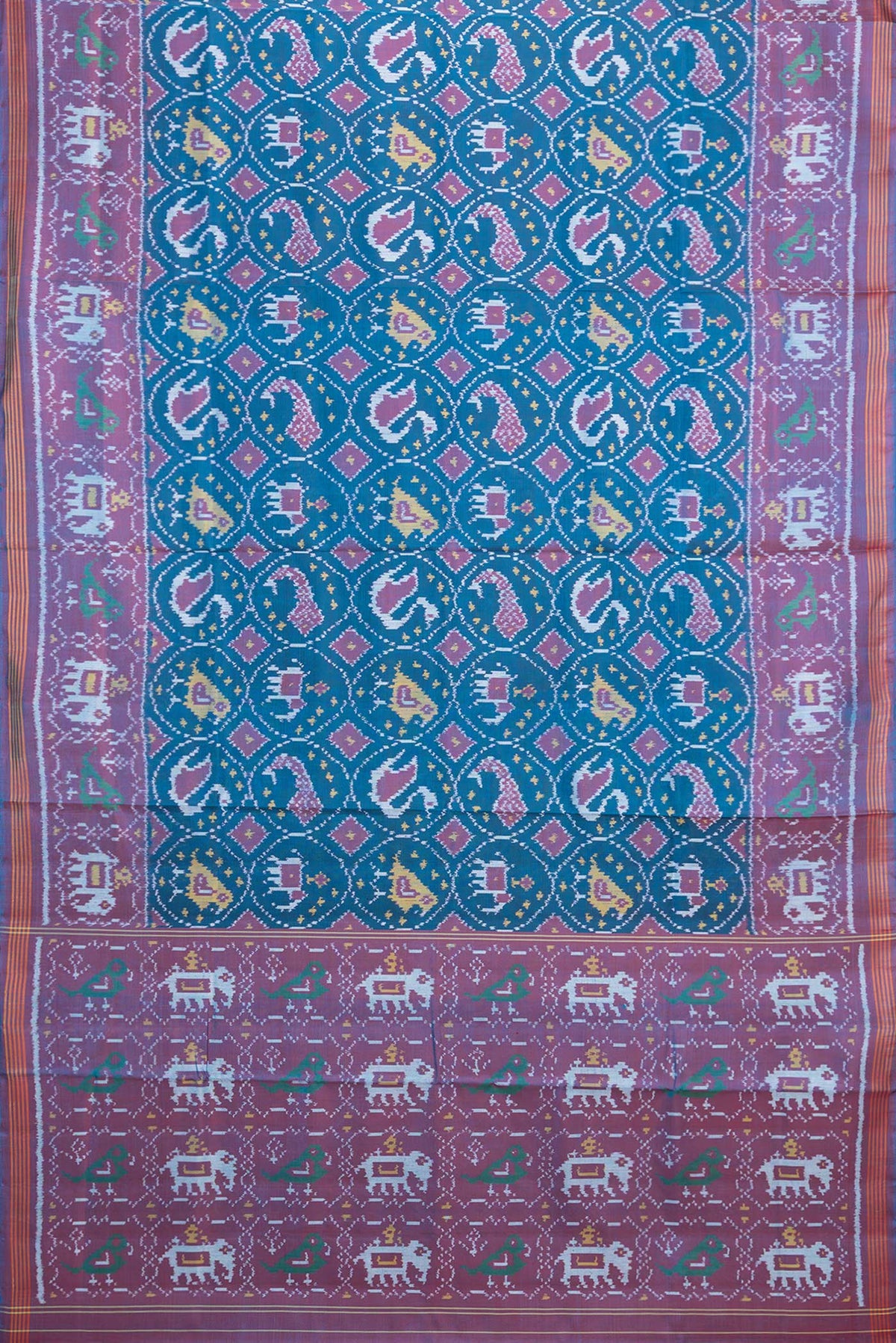 Flat view of Pure Silk Peacock Blue Rajkot Patola Saree with Pure Ikat on the body and Ikat Border. 