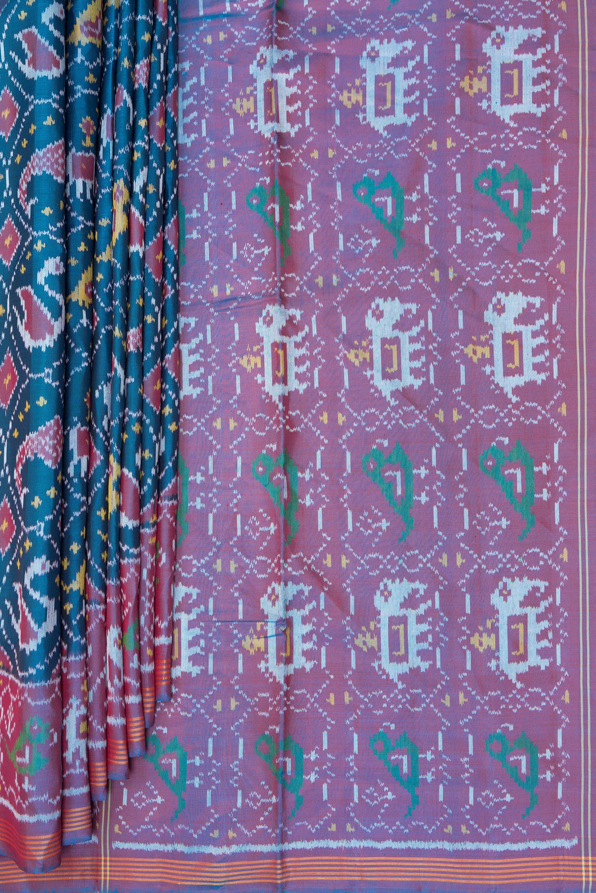 Pleats and pallu of Pure Silk Peacock Blue Rajkot Patola Saree with Pure Ikat on the body and Ikat Border. 
