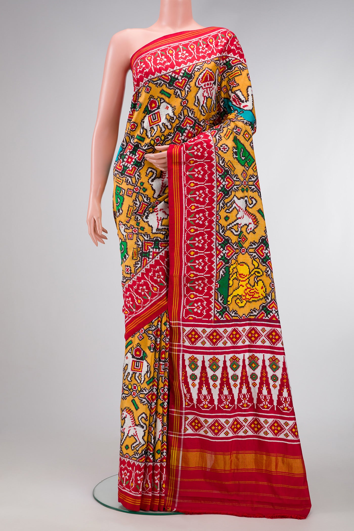 Mustard Dual Tone Double Ikat Saree with Ikat Print on the body and Ikat Border.  displayed on a mannequin