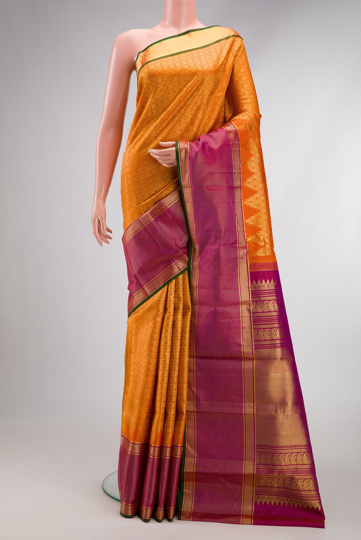 Orange Kanjivaram Silk Saree with Zari Brocade on the body and Zari Border.  displayed on a mannequin
