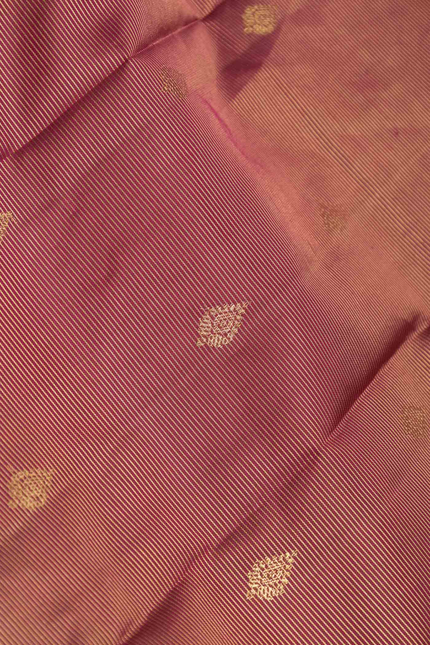 Close up of Maroon Dual Tone Kanchipuram Saree with Stripes on the body and Zari Border displaying folds
