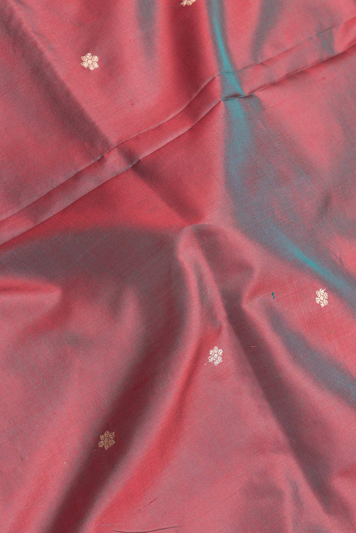 Close up of Maroon Dual Tone Banarasi Silk Saree with Thread Butta on the body and Thread Border.  displaying folds
